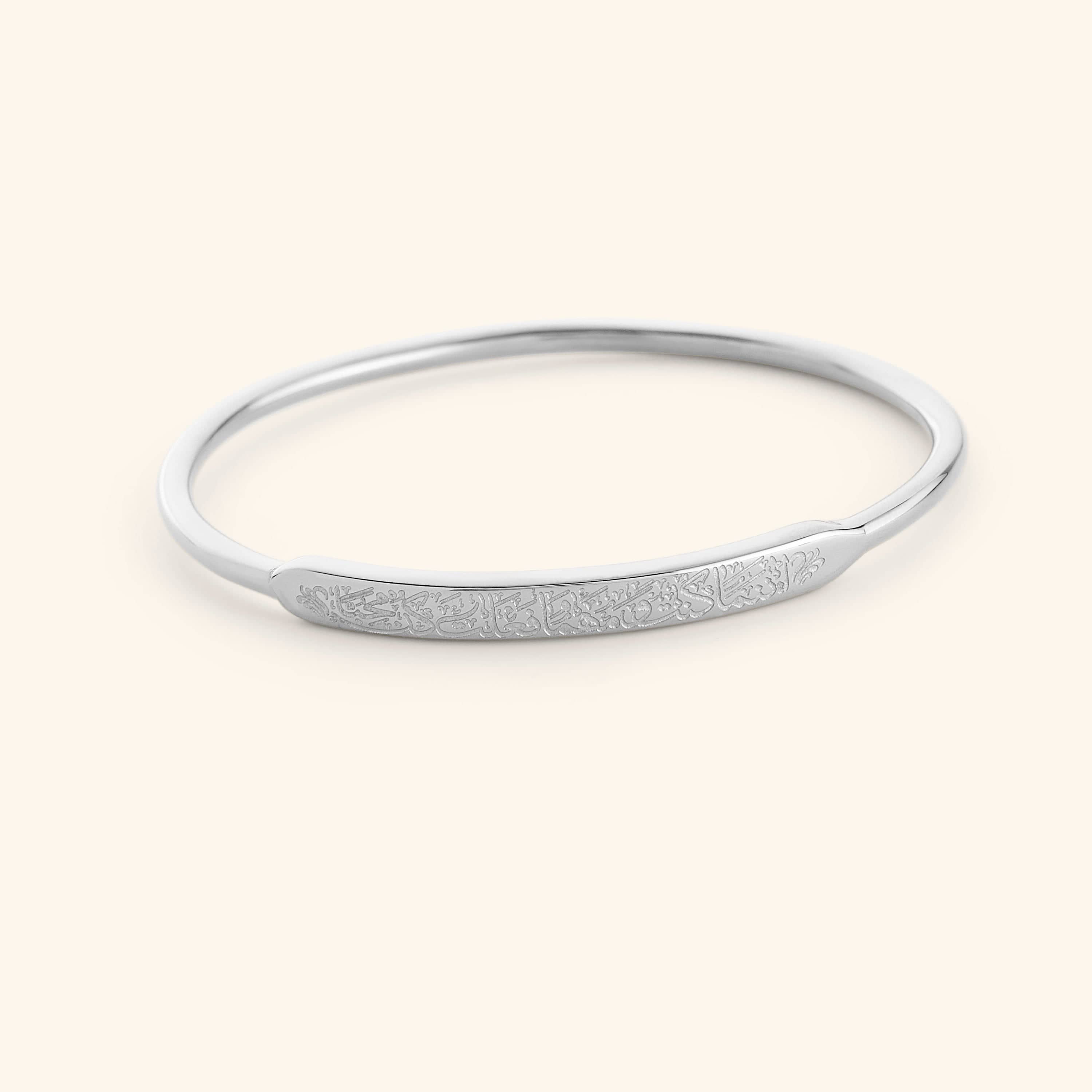 Model wearing the hypoallergenic gold bangle with quote in natural light