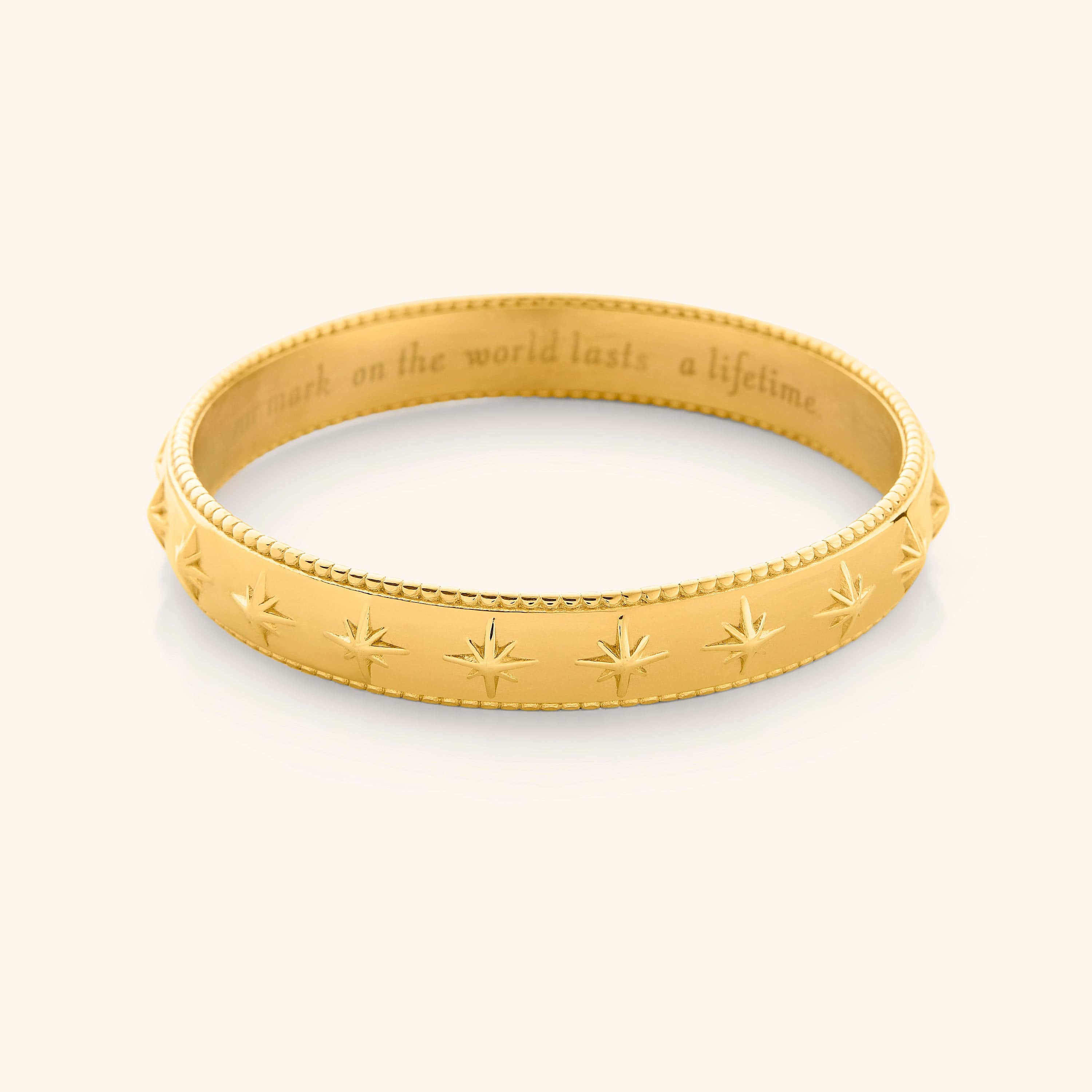 Close-up view of the Eternal Impact Bangle highlighting the embossed X's.