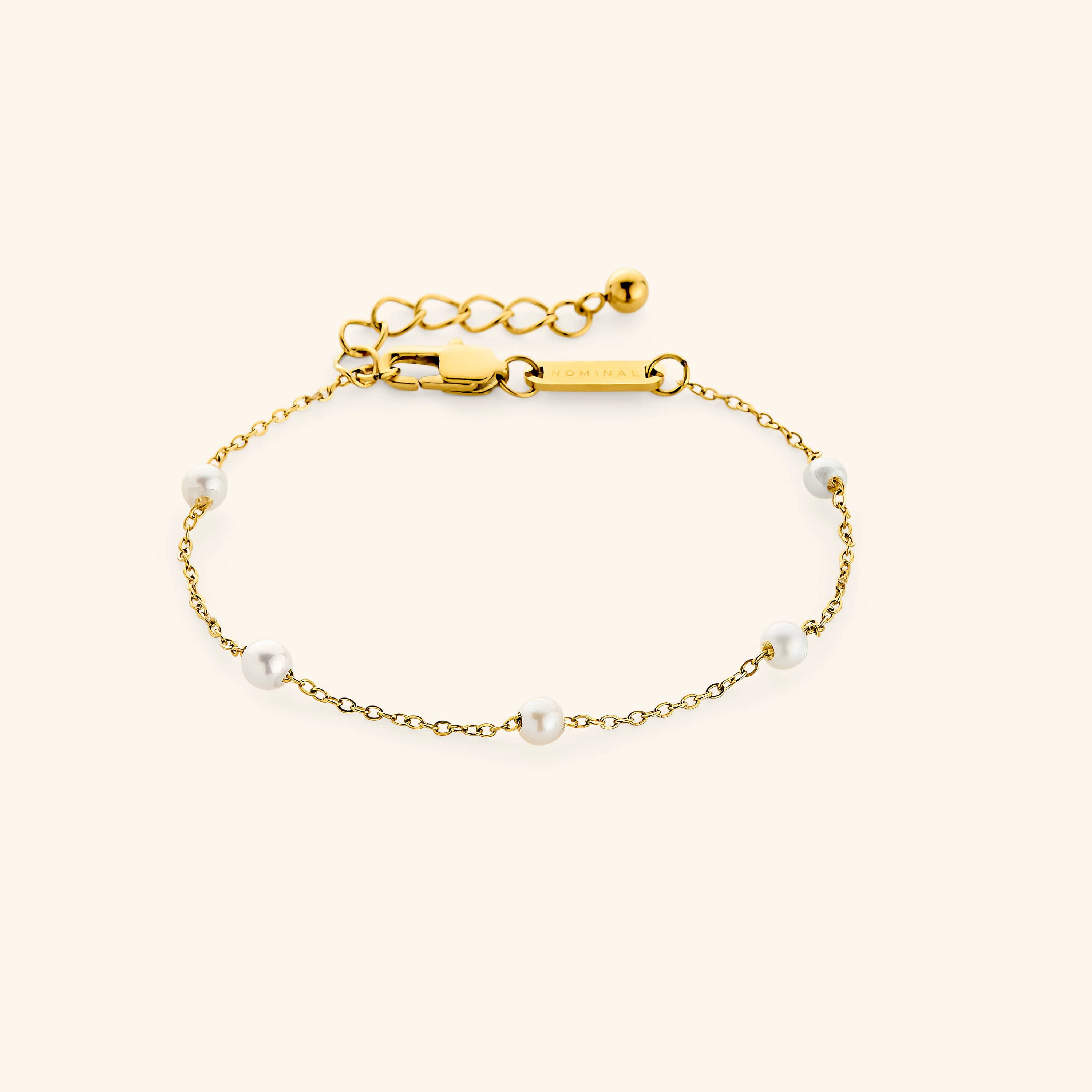 Elegant minimalist pearl bracelet displayed on a soft velvet pouch.