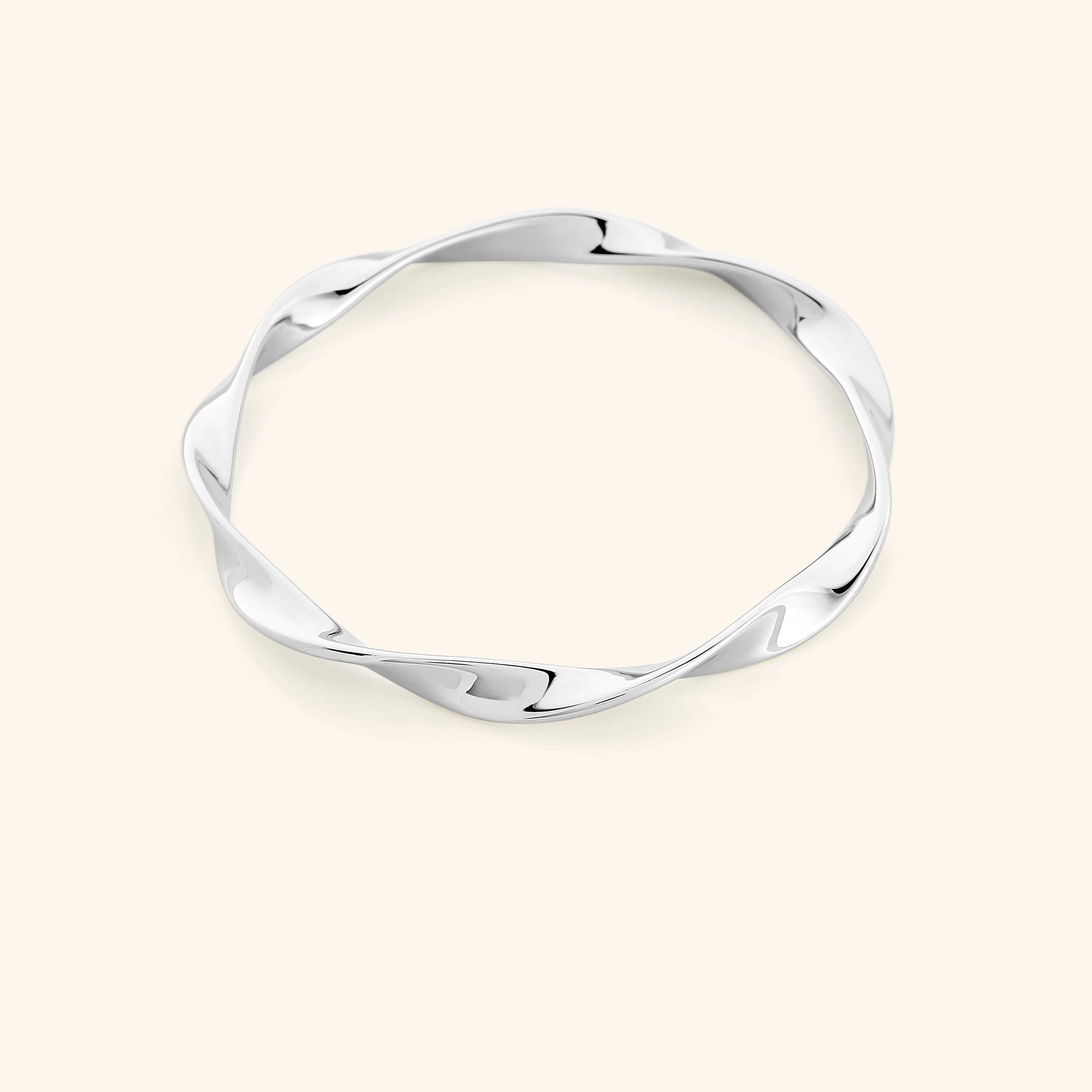 Elegant gold ripple bangle showcasing the unique design and shine.