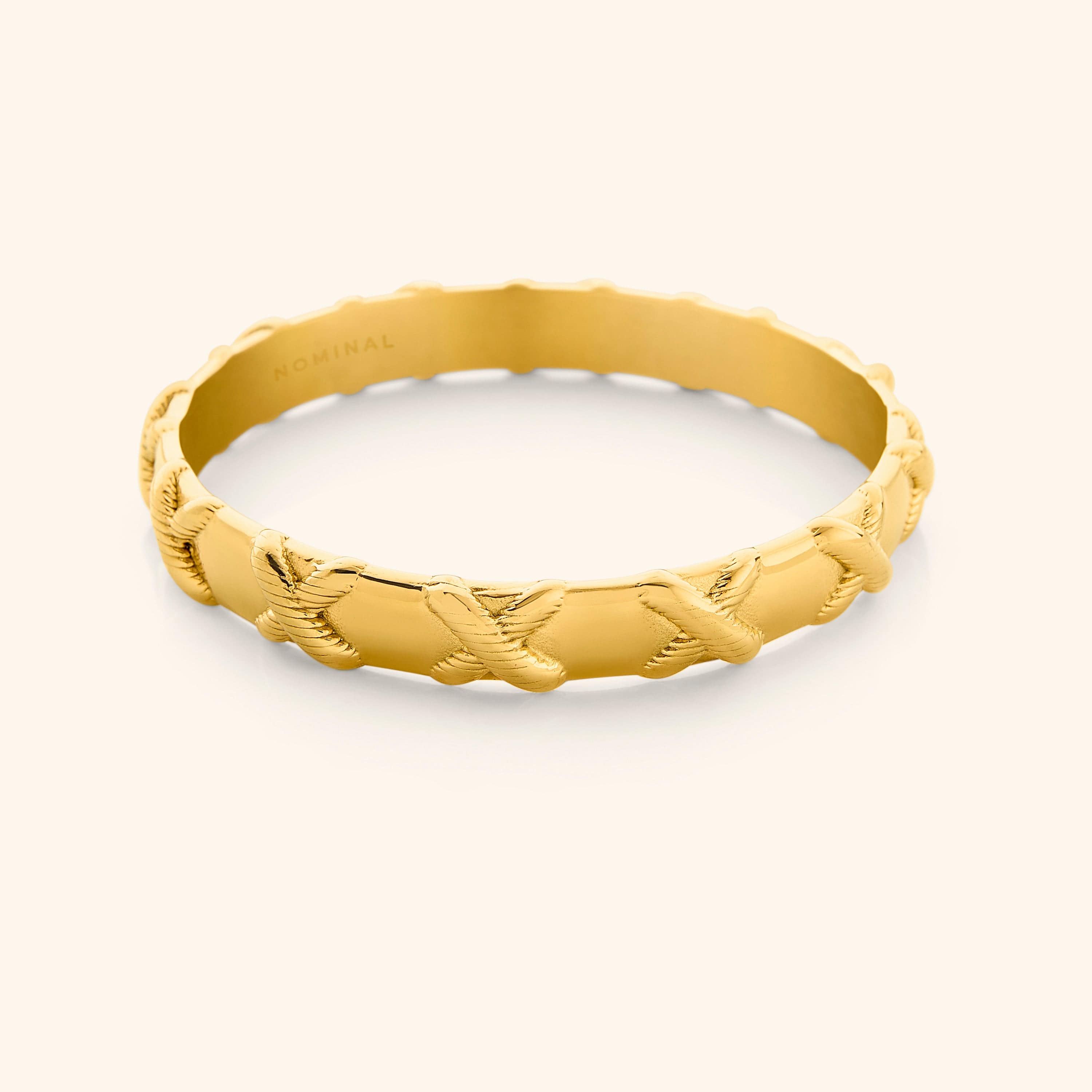 Empowerment Bangle showcasing the 'X' design, perfect for sensitive skin.