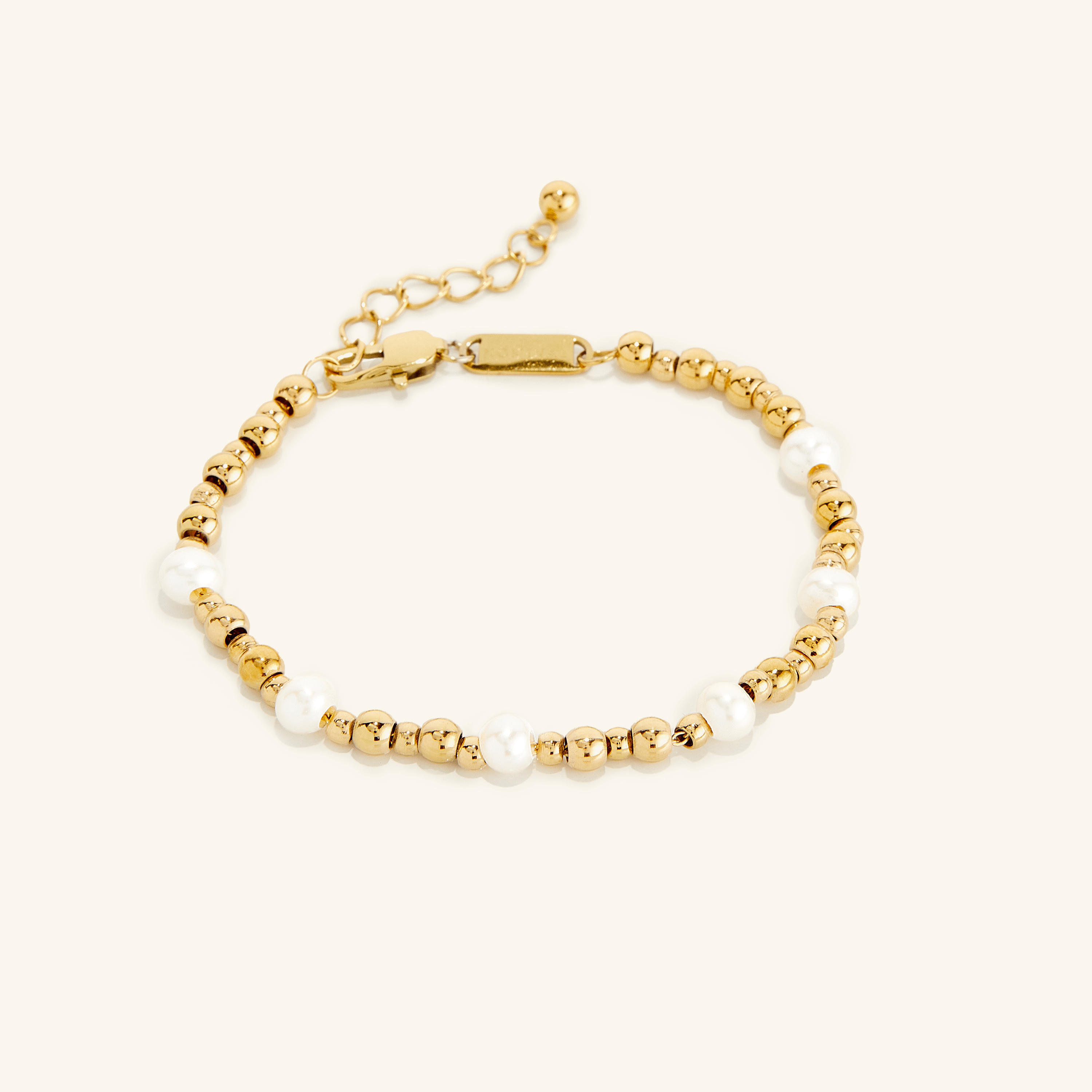 Elegant gold pearl bracelet displayed on a wrist, showcasing its beautiful freshwater pearls and gold plating.