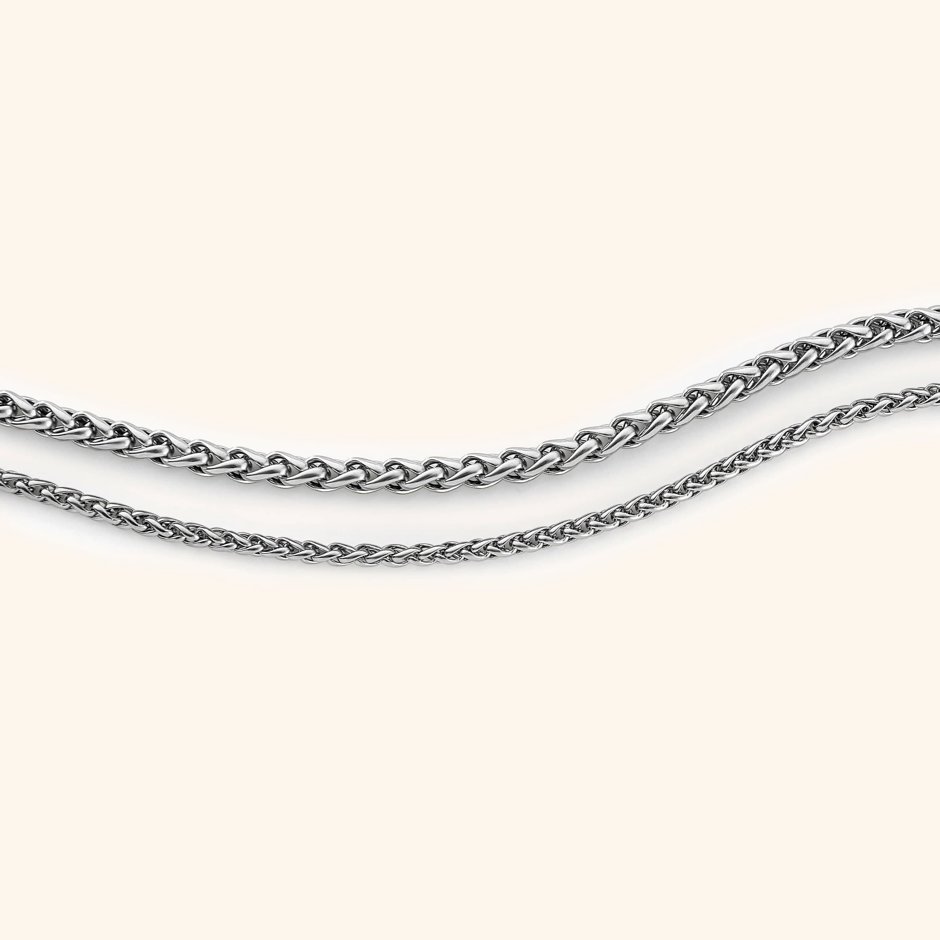 The premium wheat chain bracelet displayed in its velvet drawstring pouch, perfect for gifting.