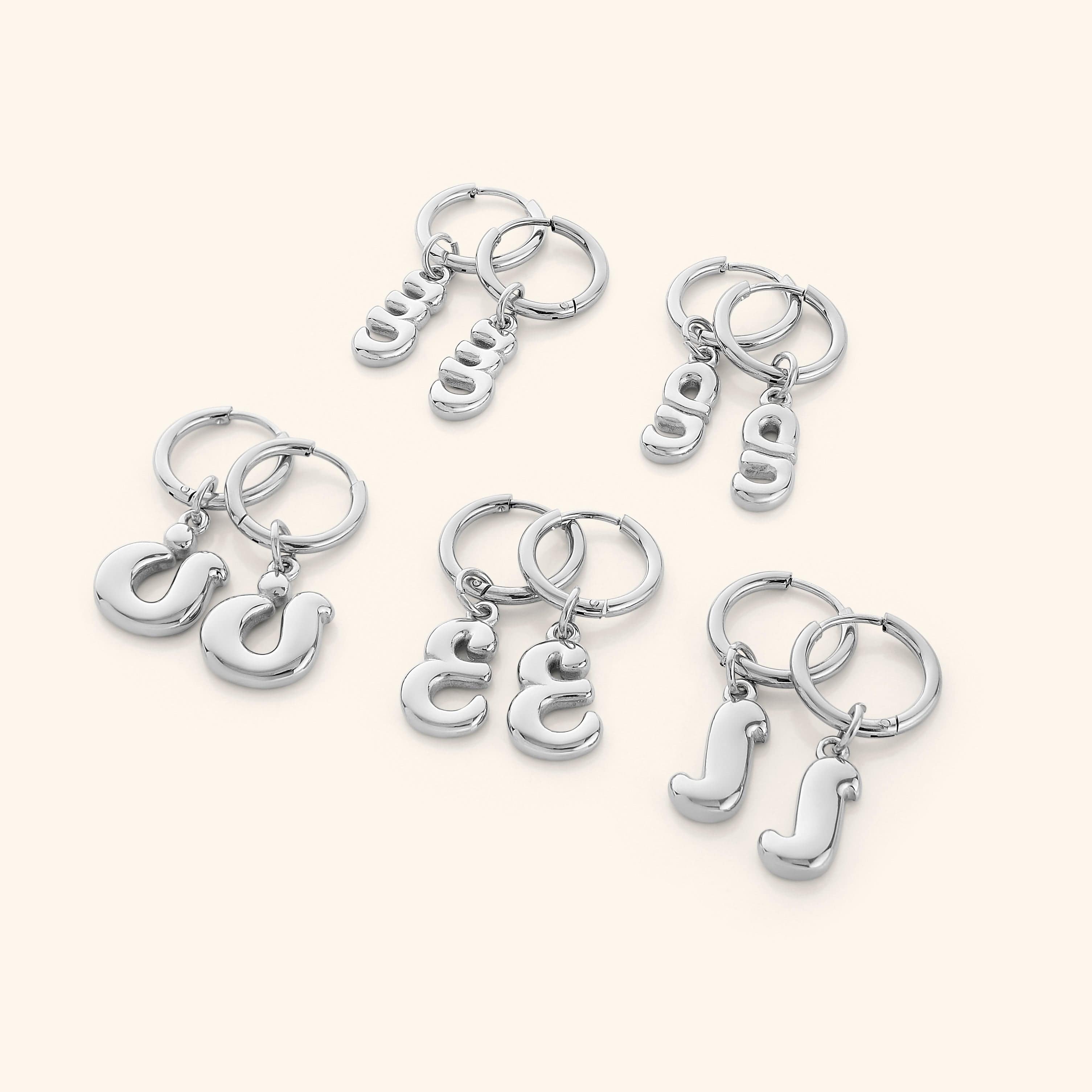 Side angle of personalized earrings worn on ear to highlight shine and size