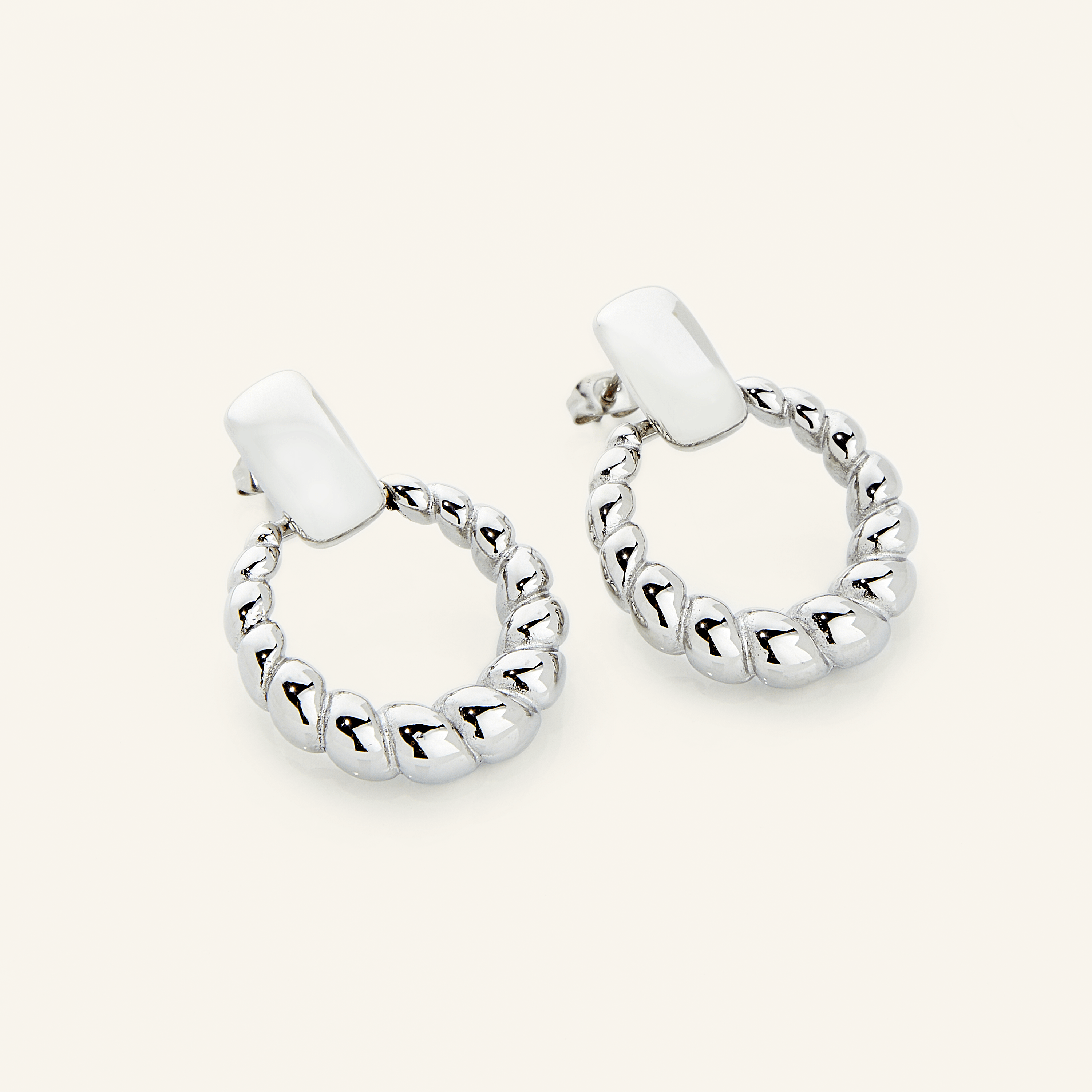 Close-up of stylish waterproof hoop earrings, highlighting the intricate braid detail.