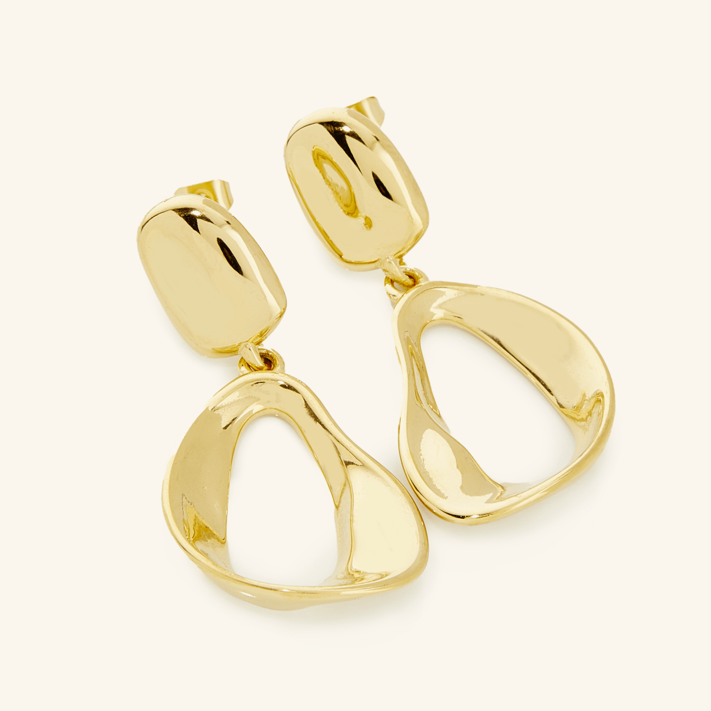 Close-up of Fluid Elegance Gold Statement Earrings highlighting the melting stud and oval hoop design.