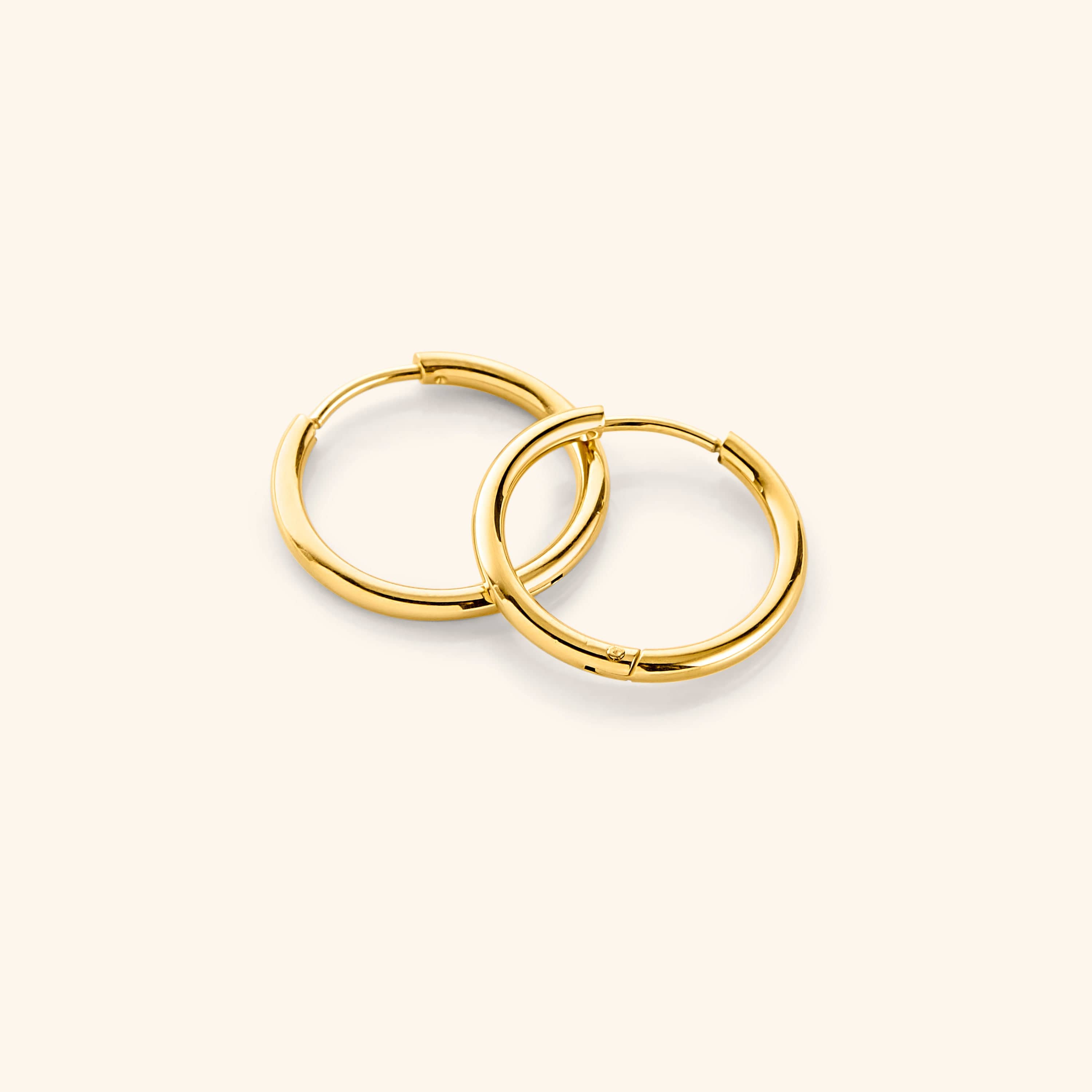 Elegant 16mm gold plated medium hoops showcasing their shine and design from the front.