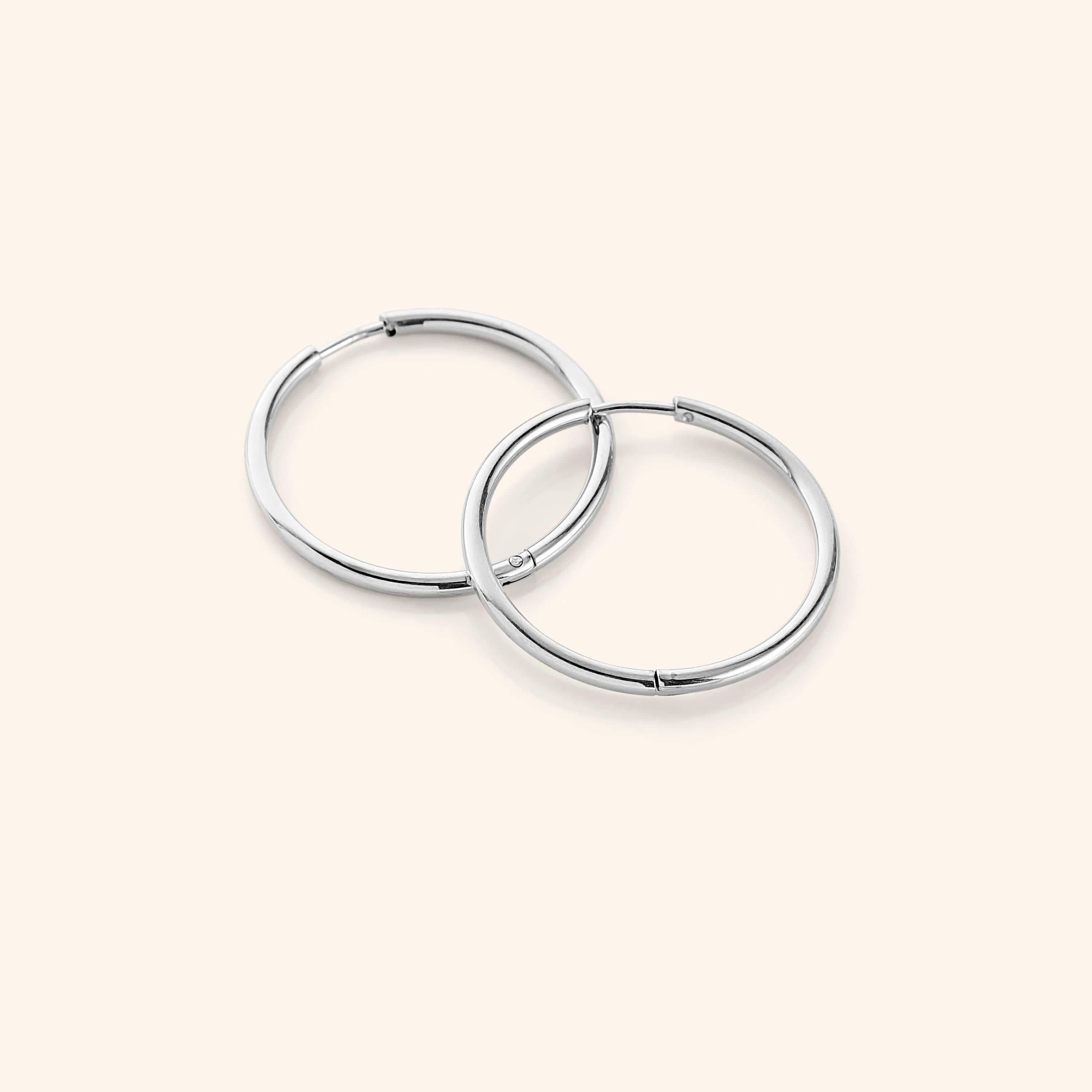 Close-up view of lightweight gold hoop earrings showing their shine and design.