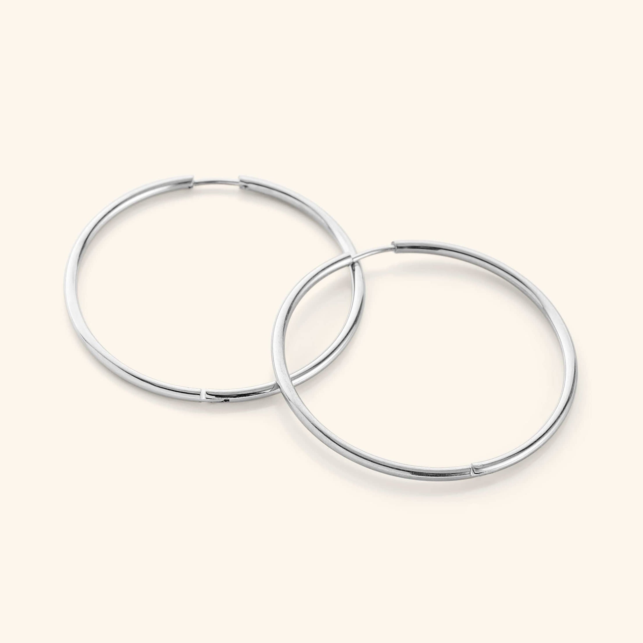 Model wearing lightweight gold hoop earrings for a casual day out.