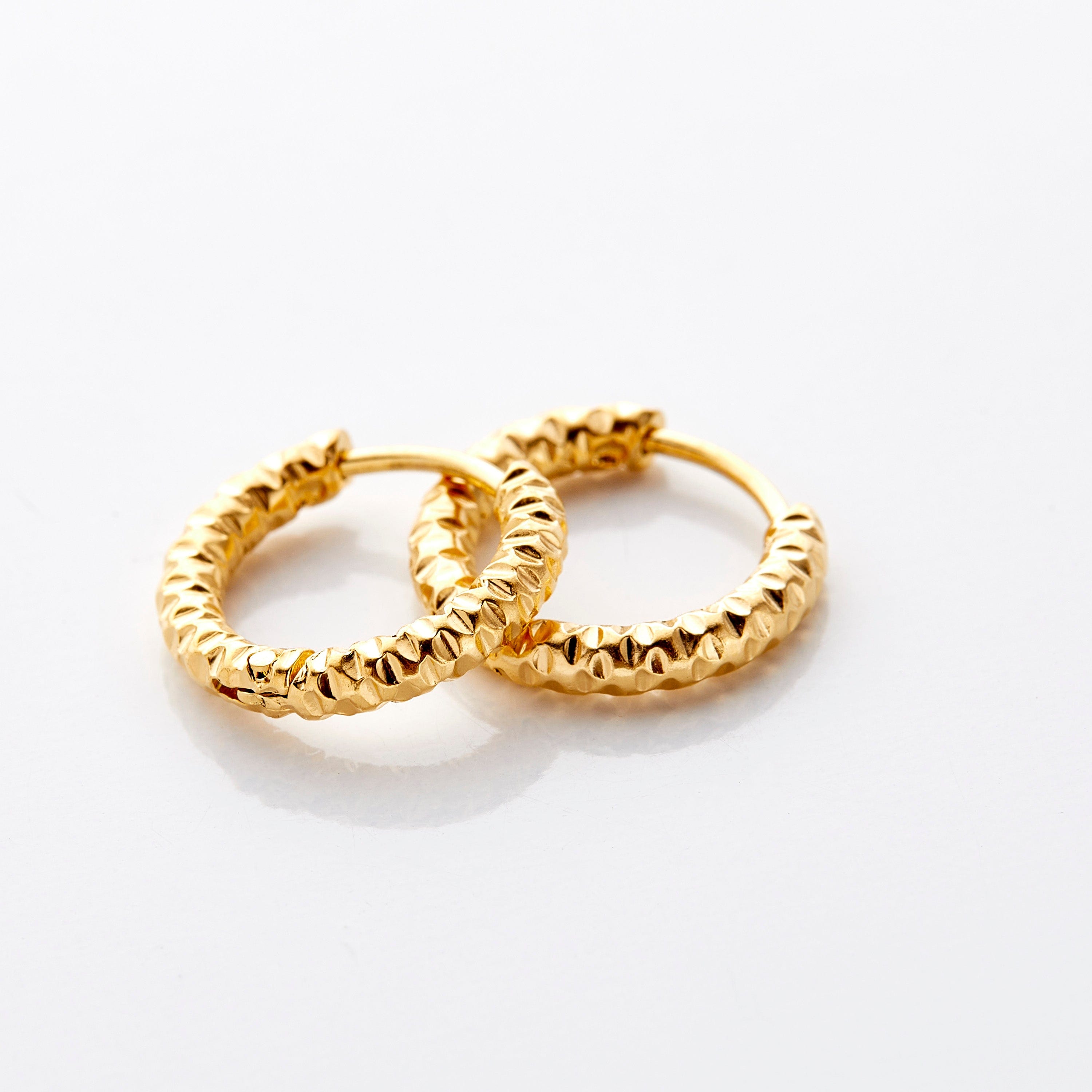 Vintage Glow Gold Hoops displayed in a velvet pouch, highlighting their elegant design.