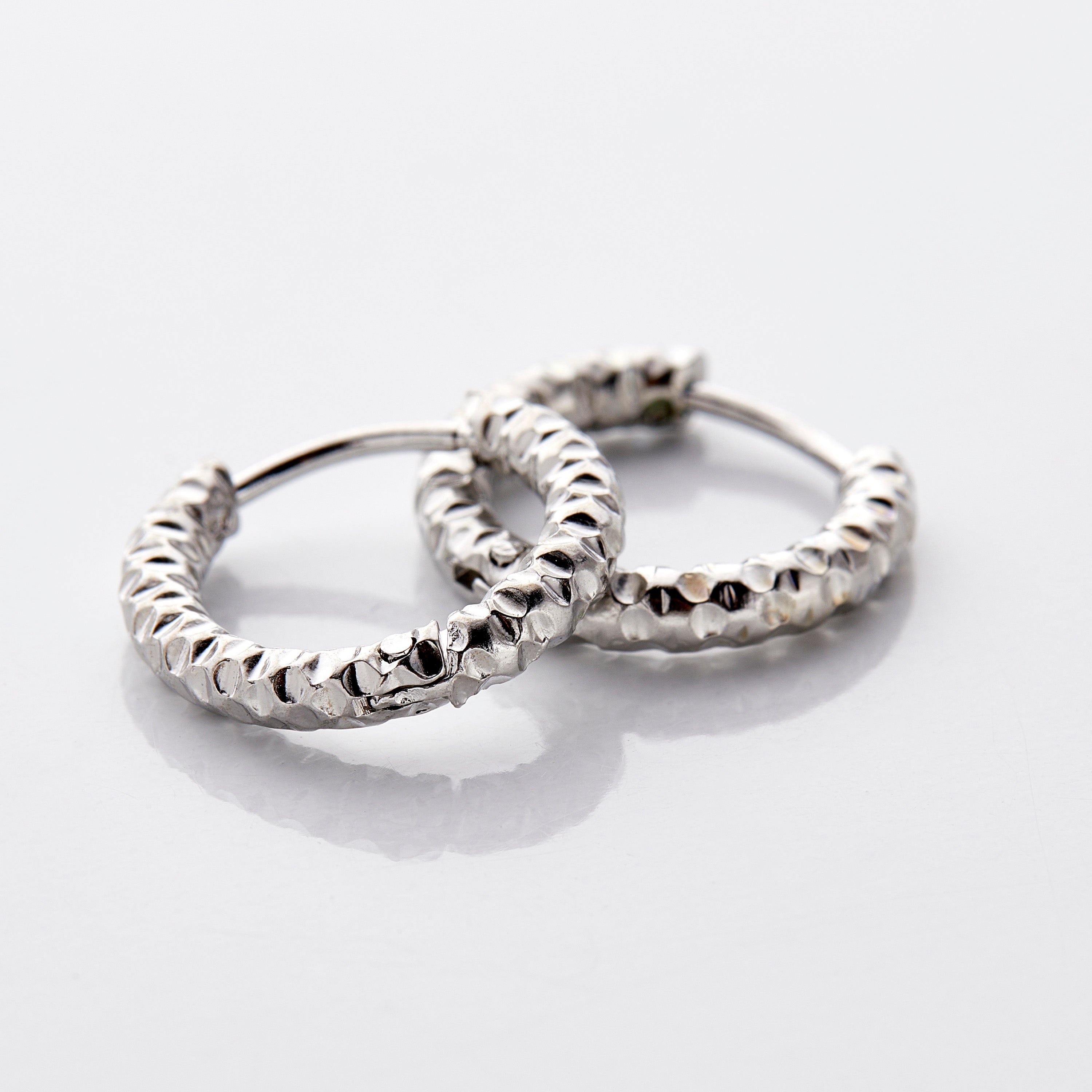 Close-up of waterproof hoop earrings, emphasizing the shiny gold finish.