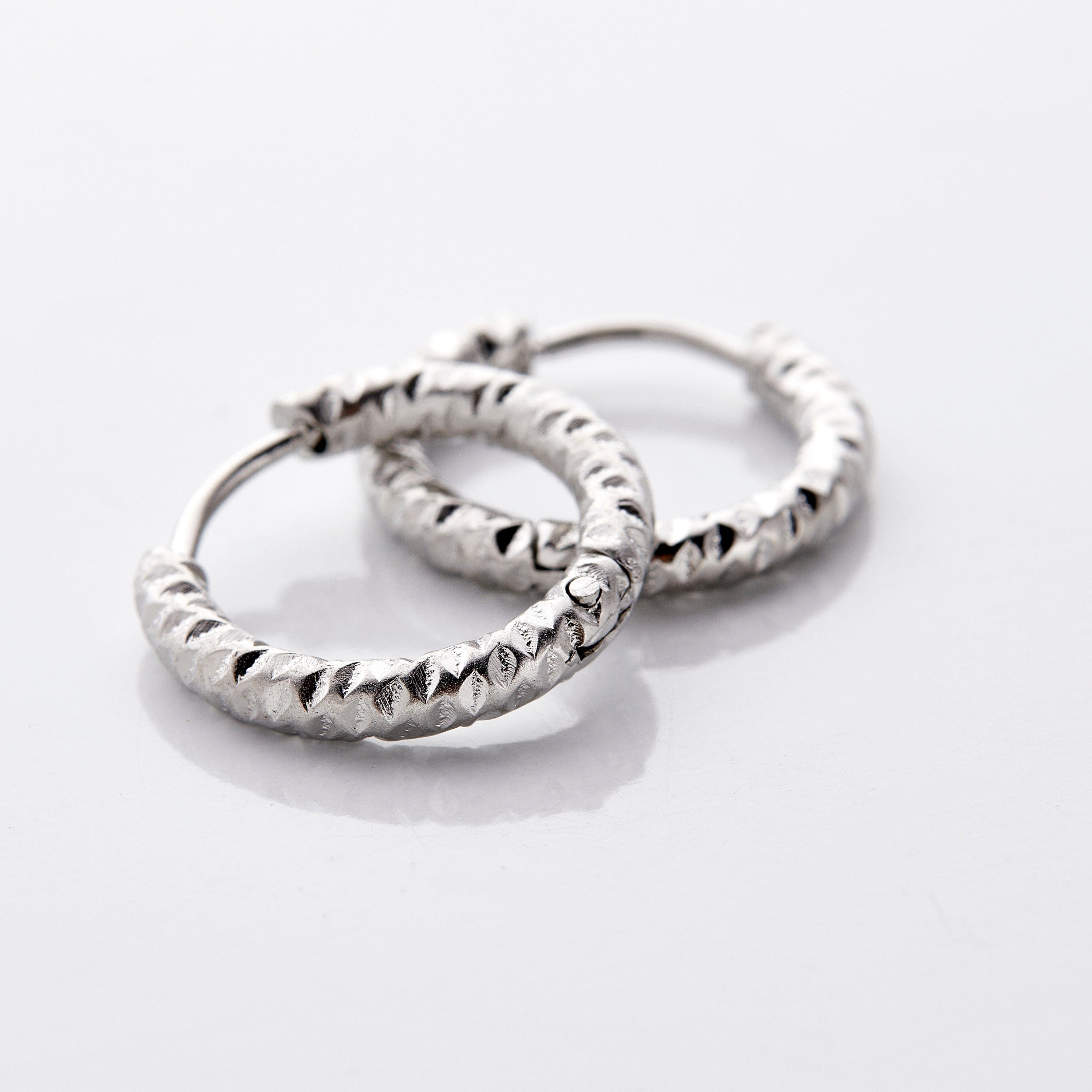 Vintage Glow Gold Hoops displayed in a velvet pouch, highlighting their elegant design.