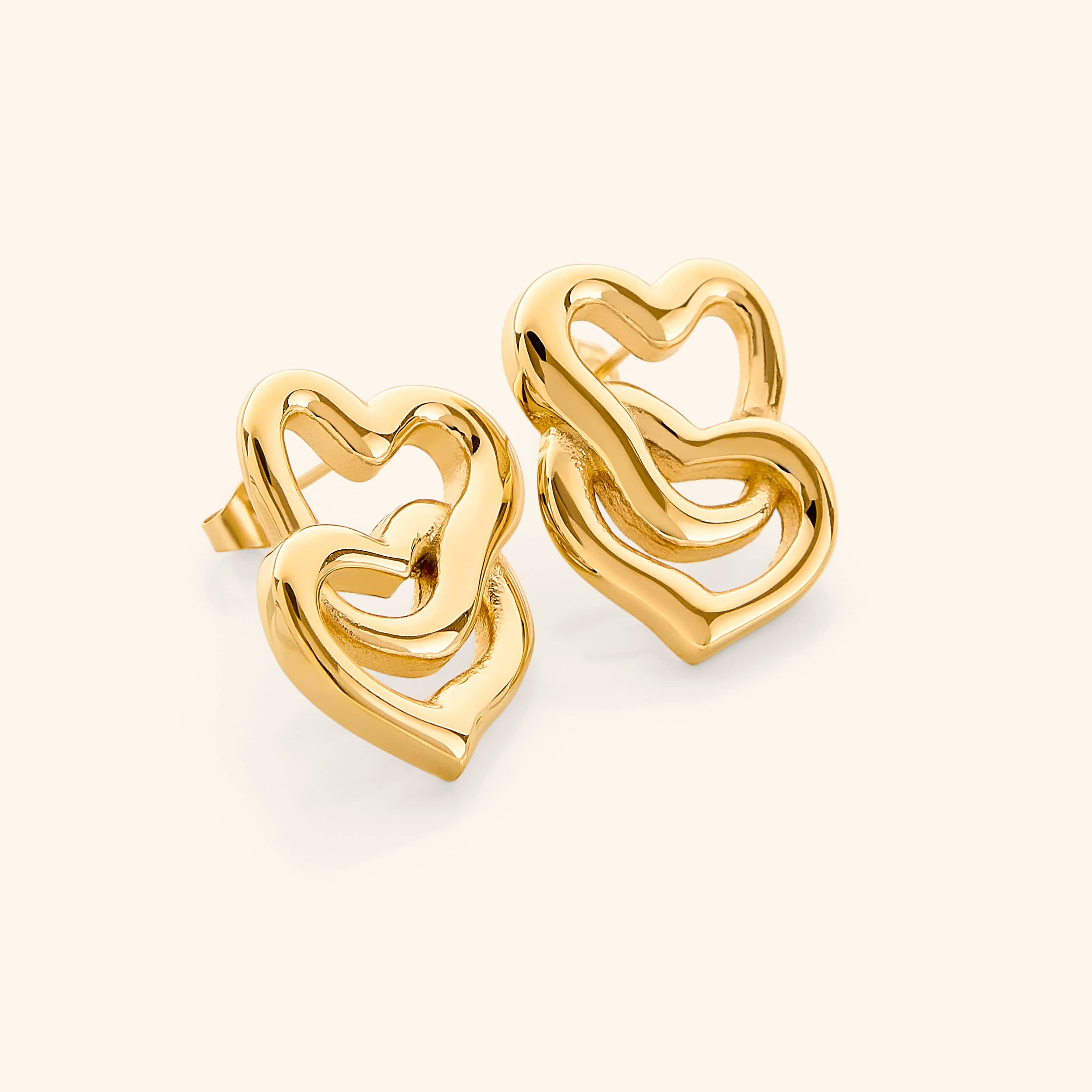 Close-up of LoveFusion Statement Earrings showing intricate heart design and gold finish.