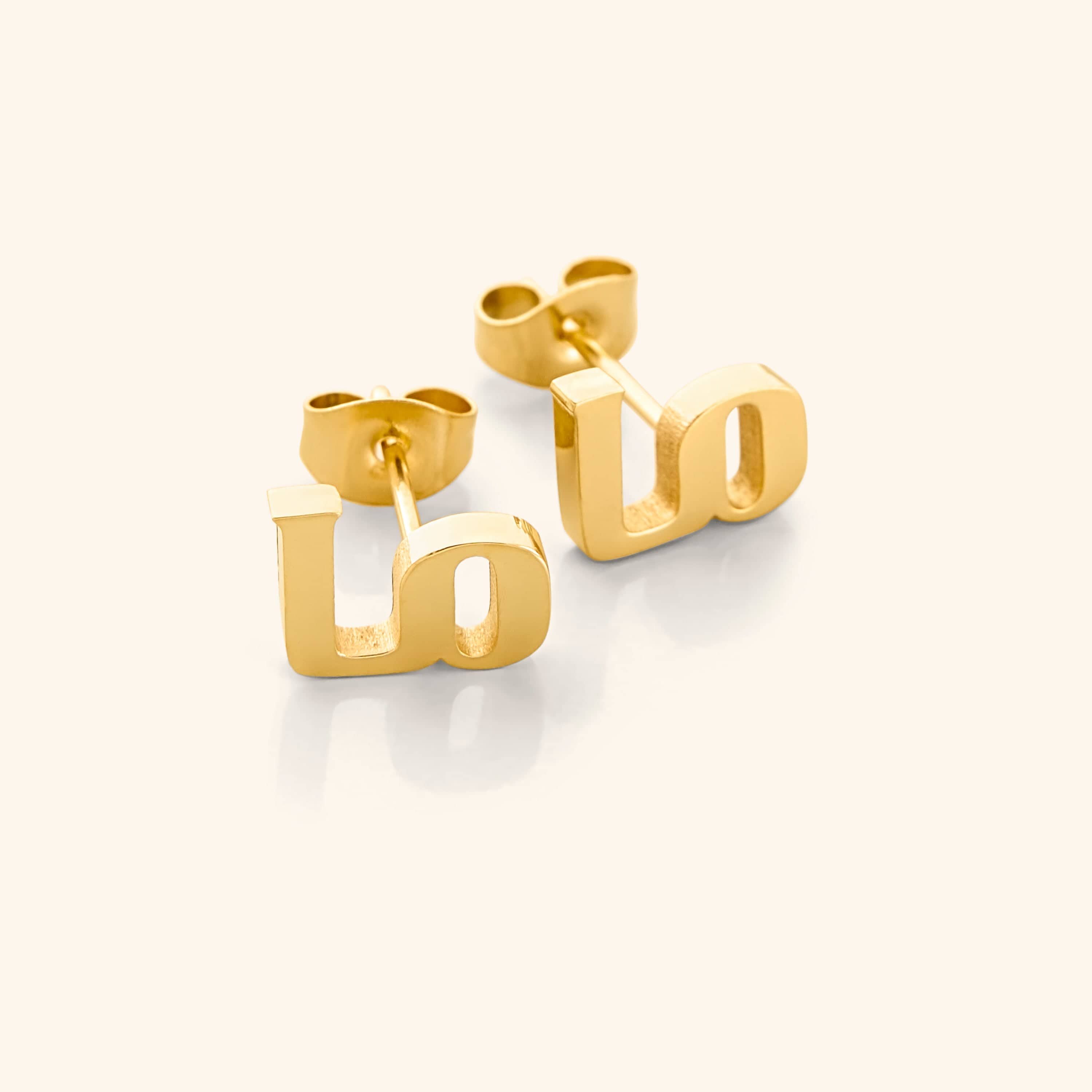 Close-up view of Mama Love minimalist earrings showcasing Arabic calligraphy.