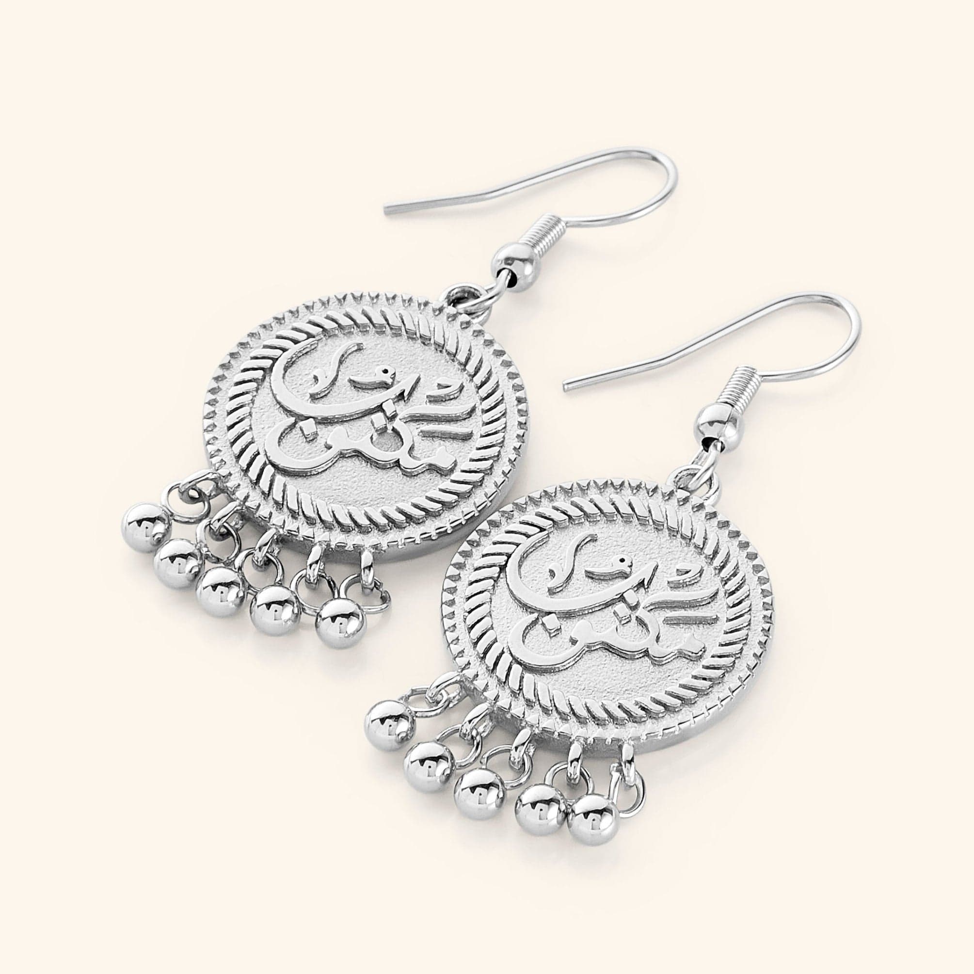 Detailed view of Heritage Charm Vintage Coin Earrings showcasing the intricate Arabic engraving.