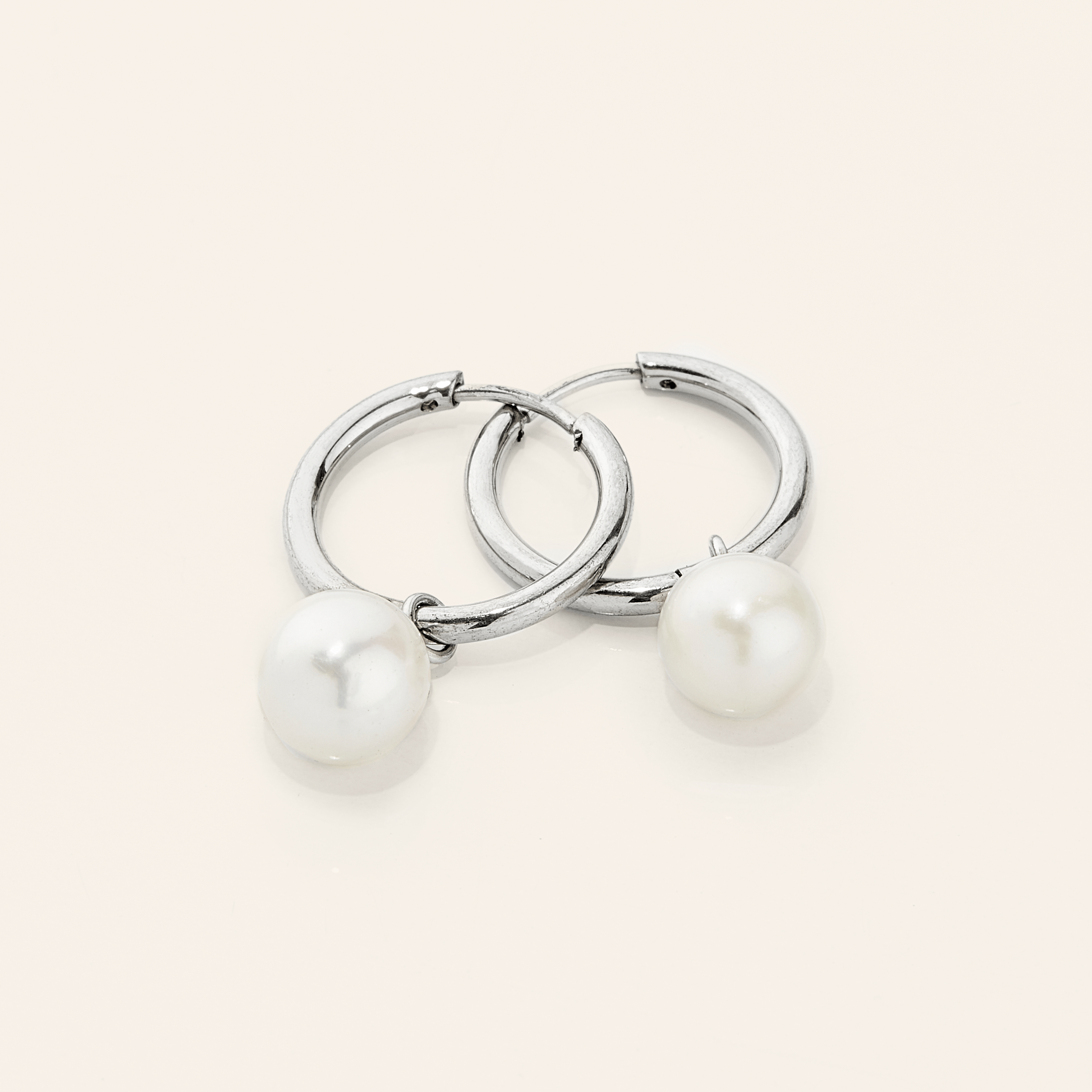 Close-up view of the minimal hoop design with pearls, perfect for fashion jewelry lovers.