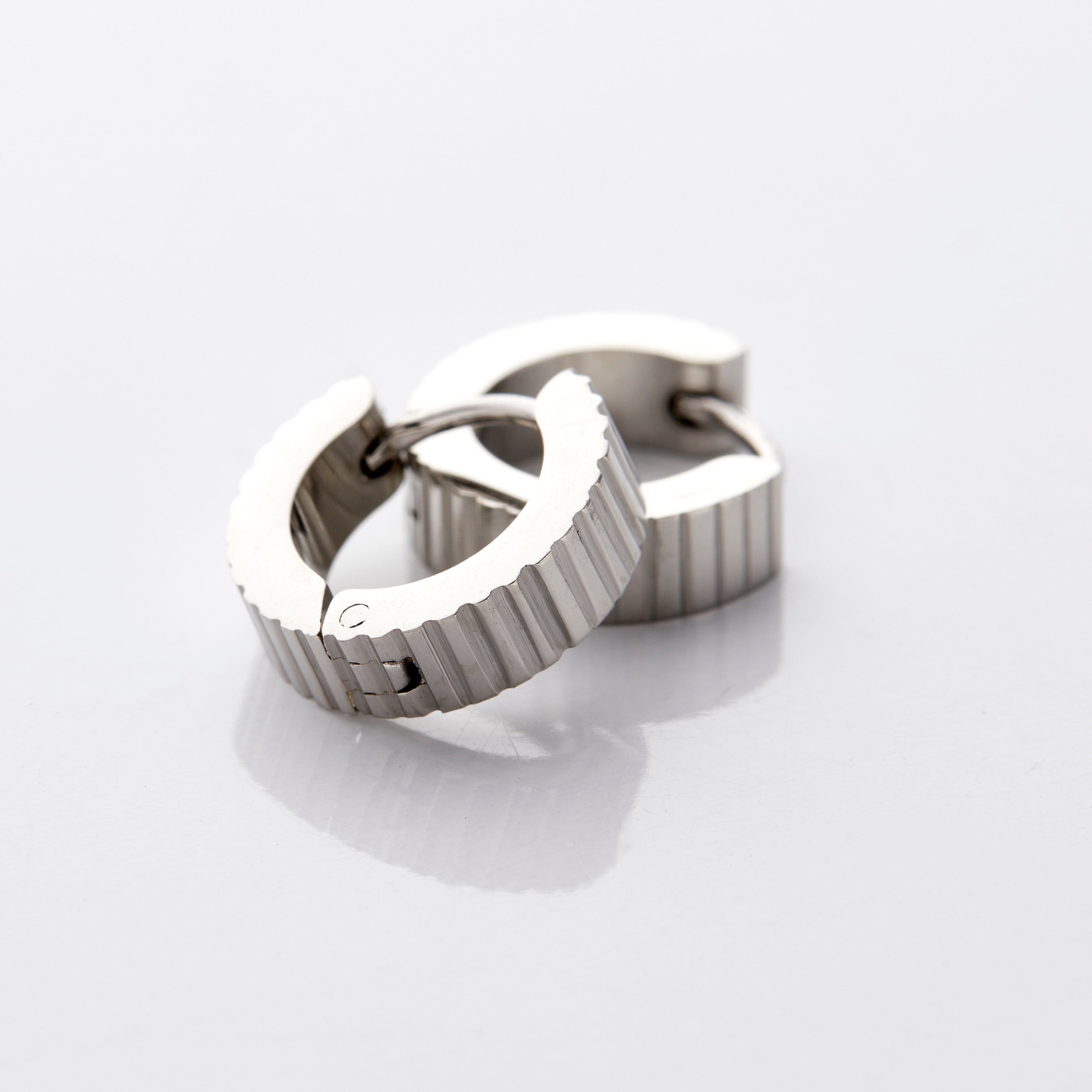 Elegant gold hoop earrings displayed in a velvet pouch, ideal for gifting.