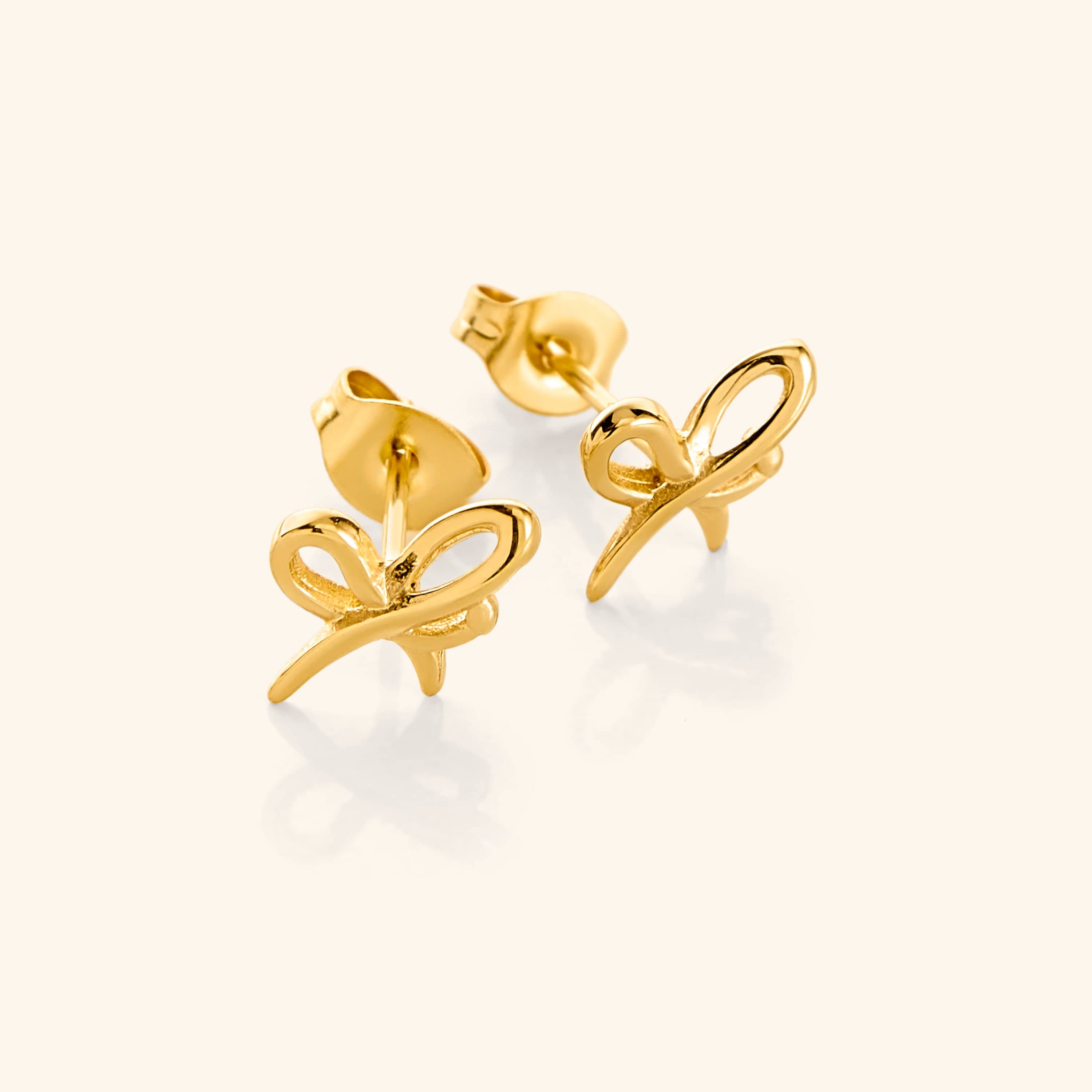 Elegant Mama Ribbon Studs showcasing their intricate design and gold finish.