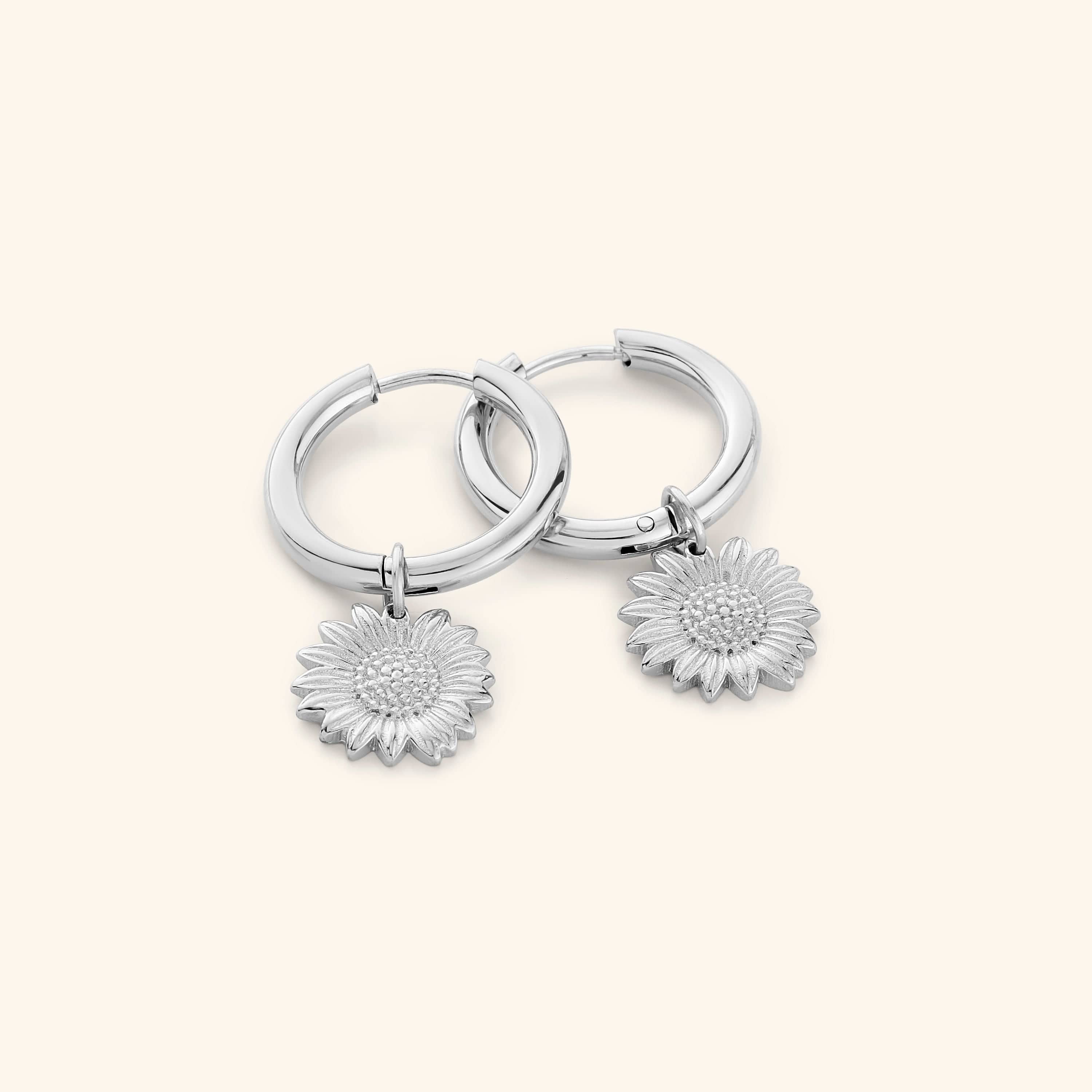 Radiant sunflower mini-hoop earrings close-up, showcasing the gold finish.
