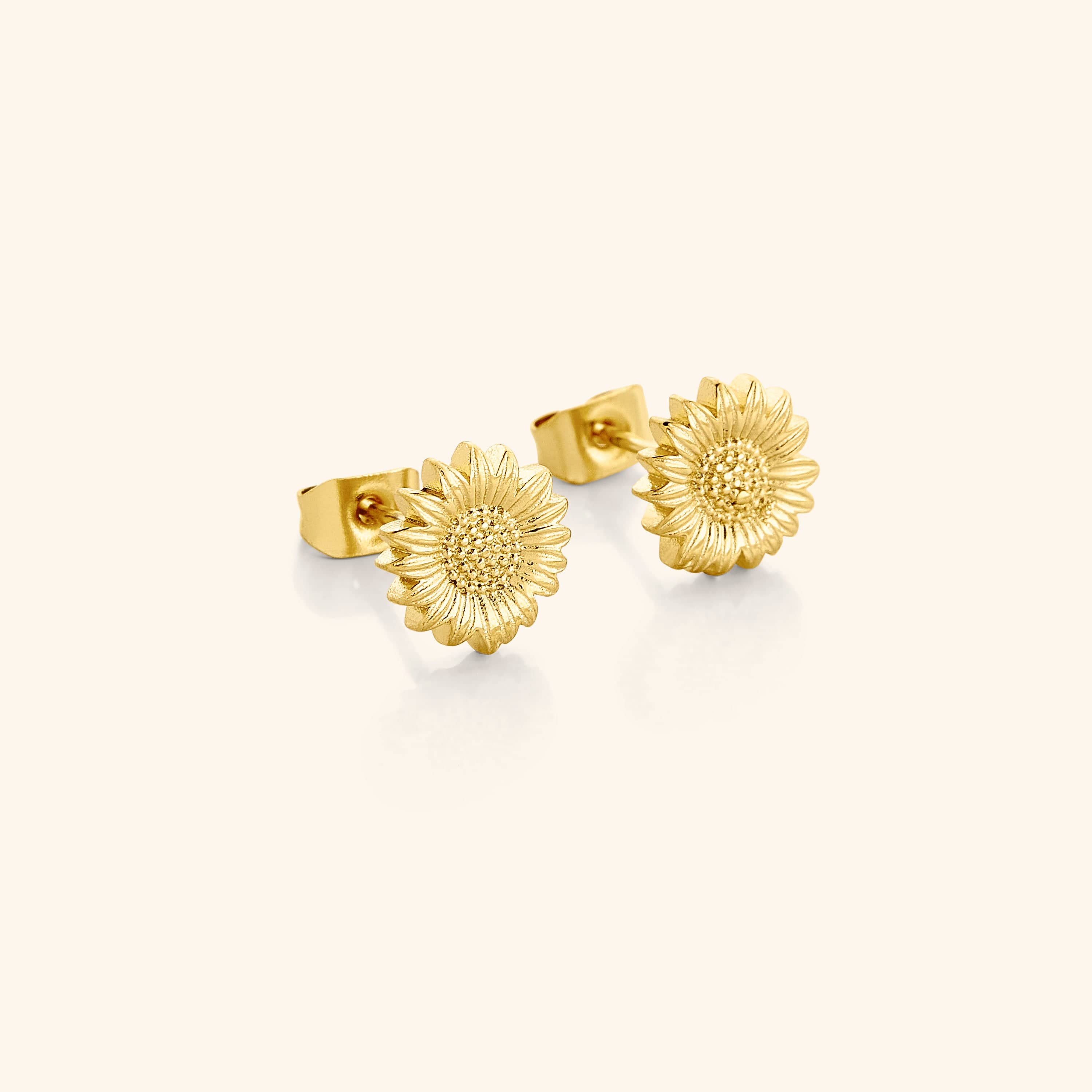 Close-up of radiant sunflower gold stud earrings showcasing 18K gold craftsmanship.