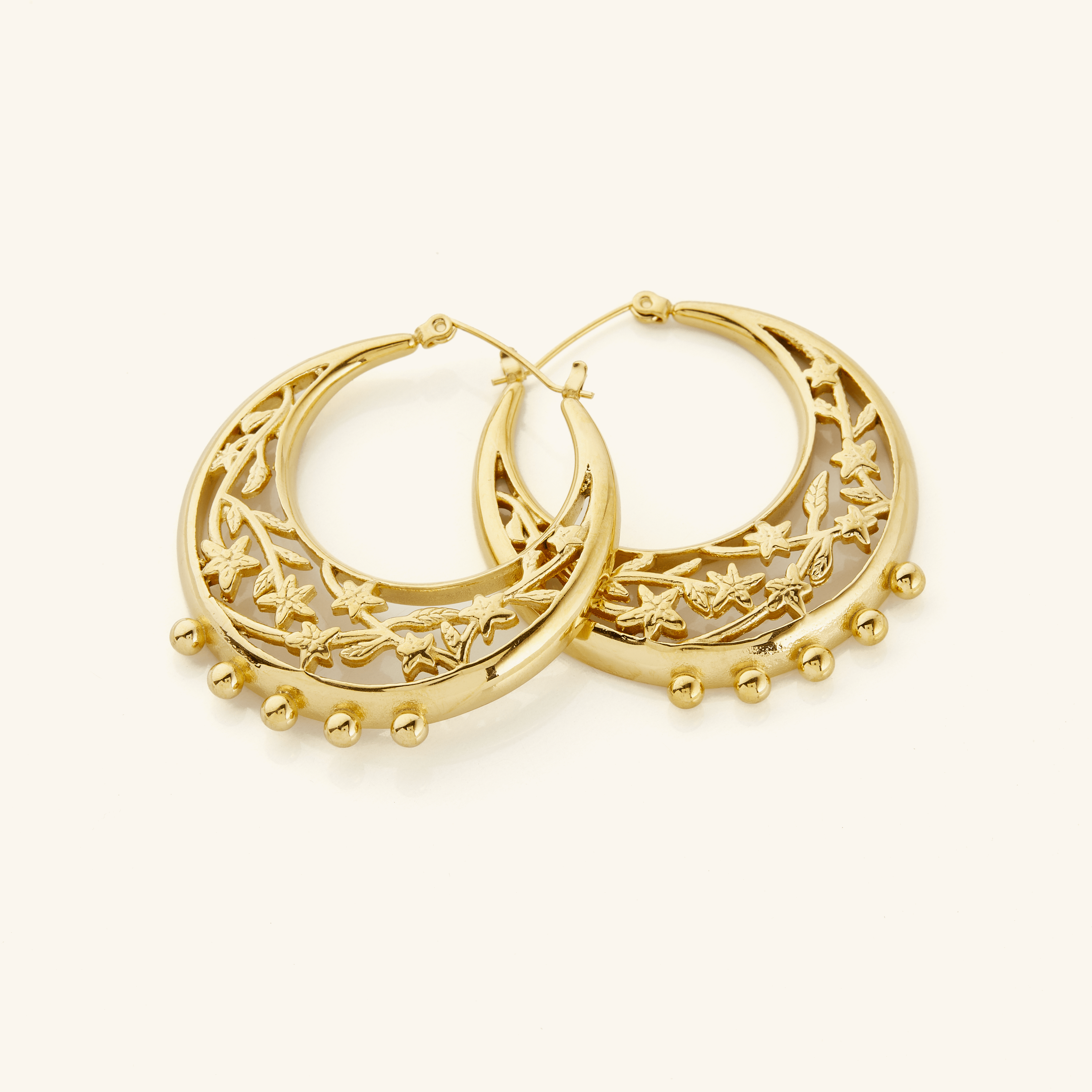 Celestial jasmine gold hoop earrings showcasing intricate design from the side.