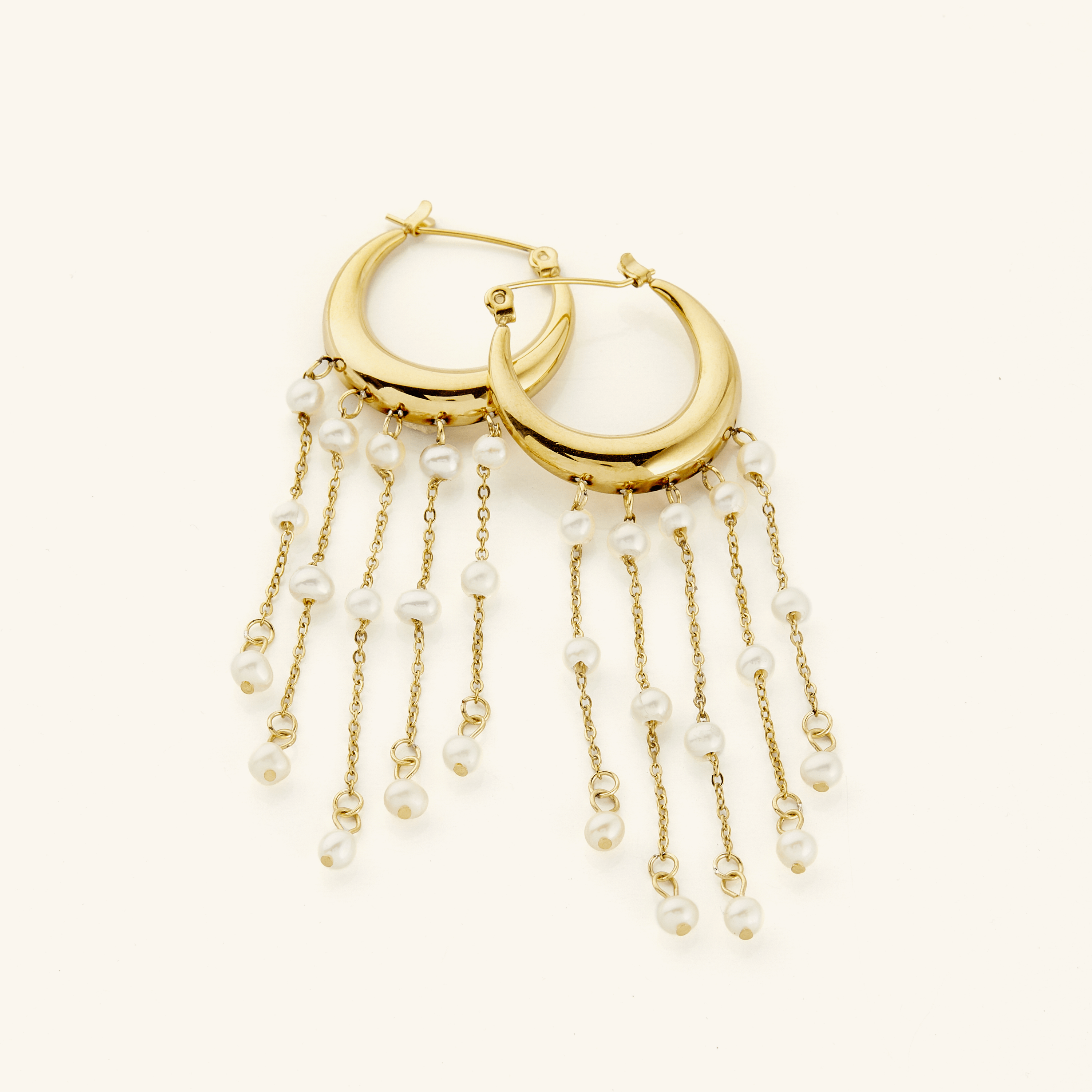 Close-up of celestial pearl cascade hoop earrings showcasing the gold and freshwater pearls.