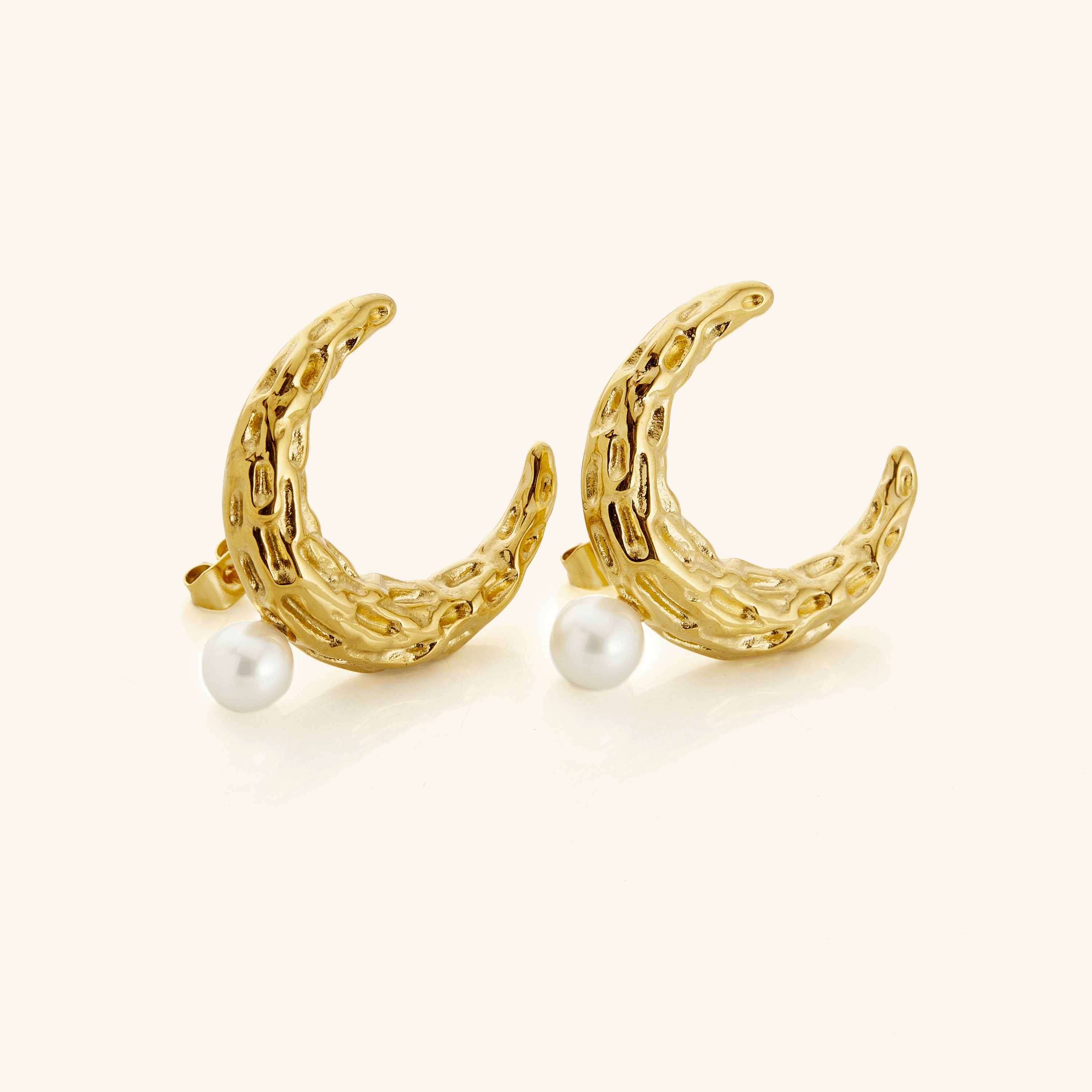 Cascading Pearl Crescent Earrings showcasing their intricate design and lustrous pearl.