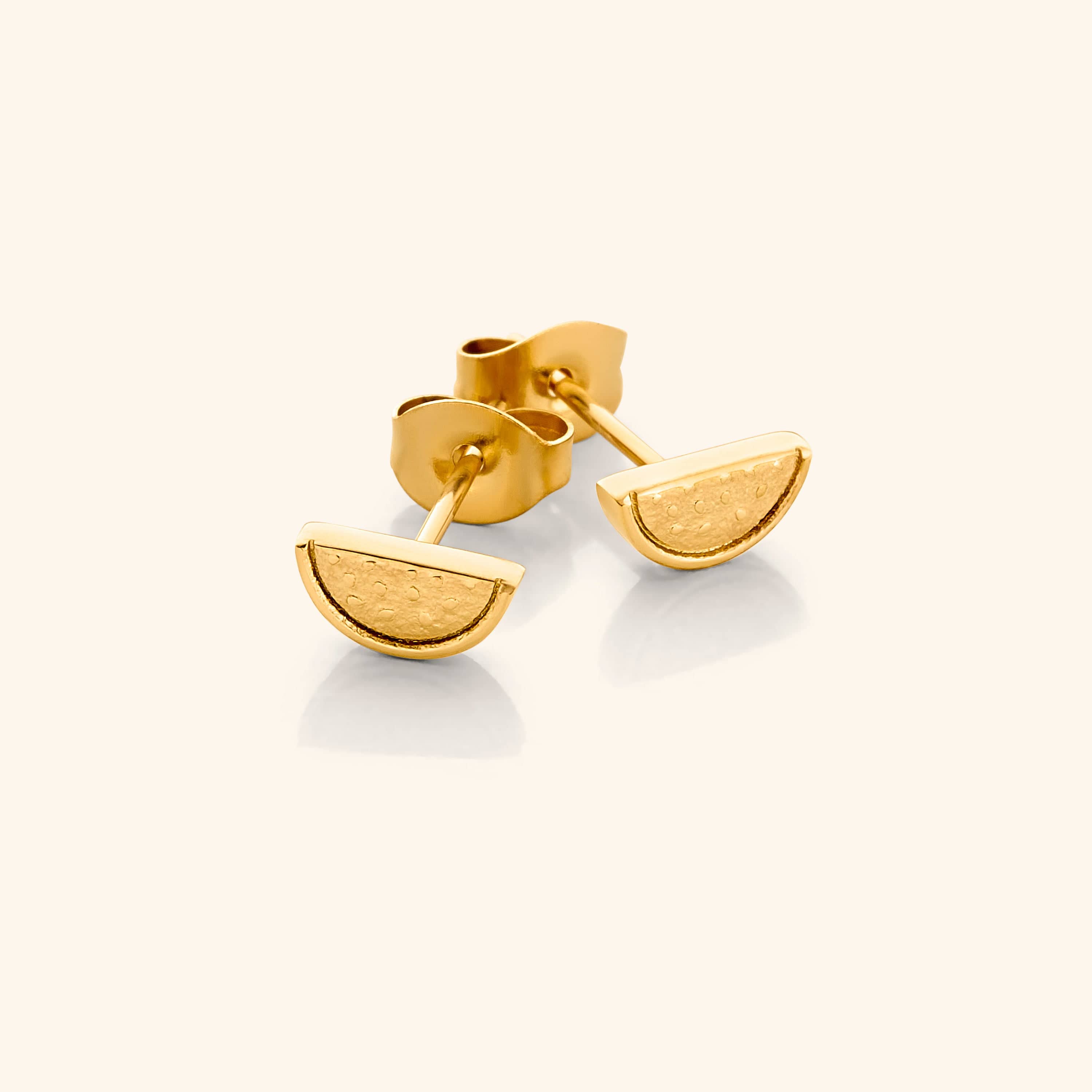 Close-up of vibrant watermelon studs showcasing their intricate design and gold plating.