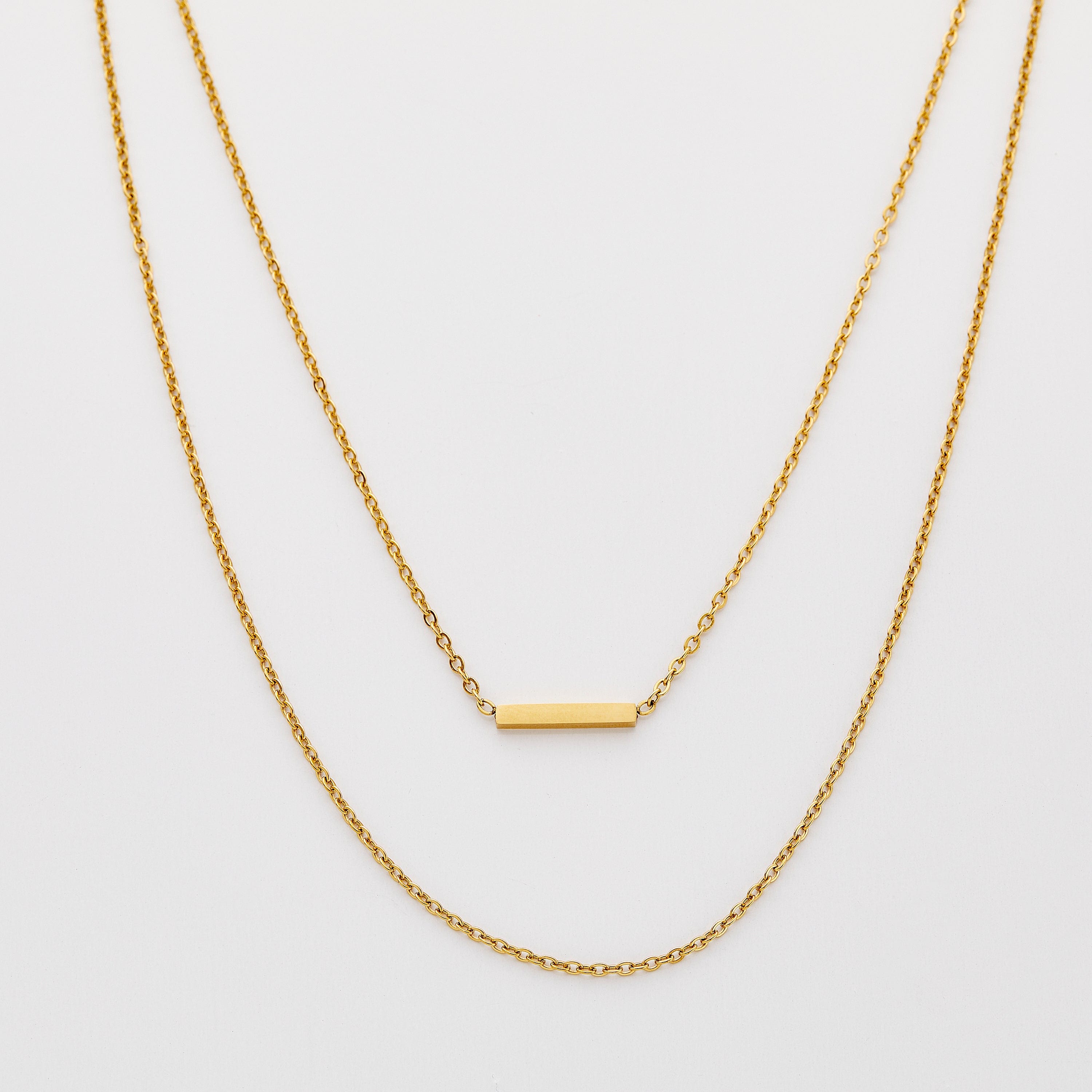 Gold adjustable necklace set displayed on a model showcasing layering options.