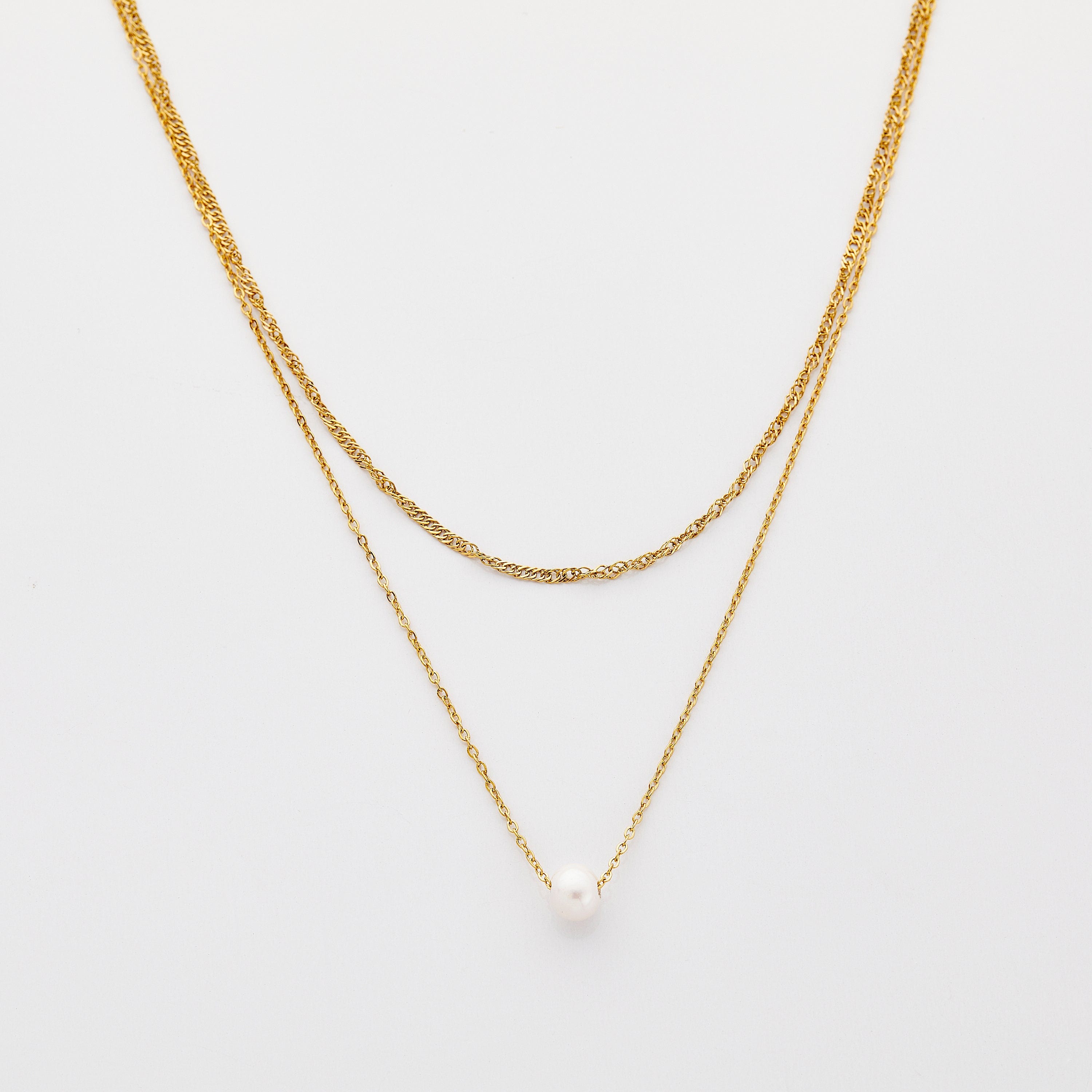 Elegant layered pearl necklace set displayed on a velvet background, showcasing the adjustable gold chain and freshwater pearl.