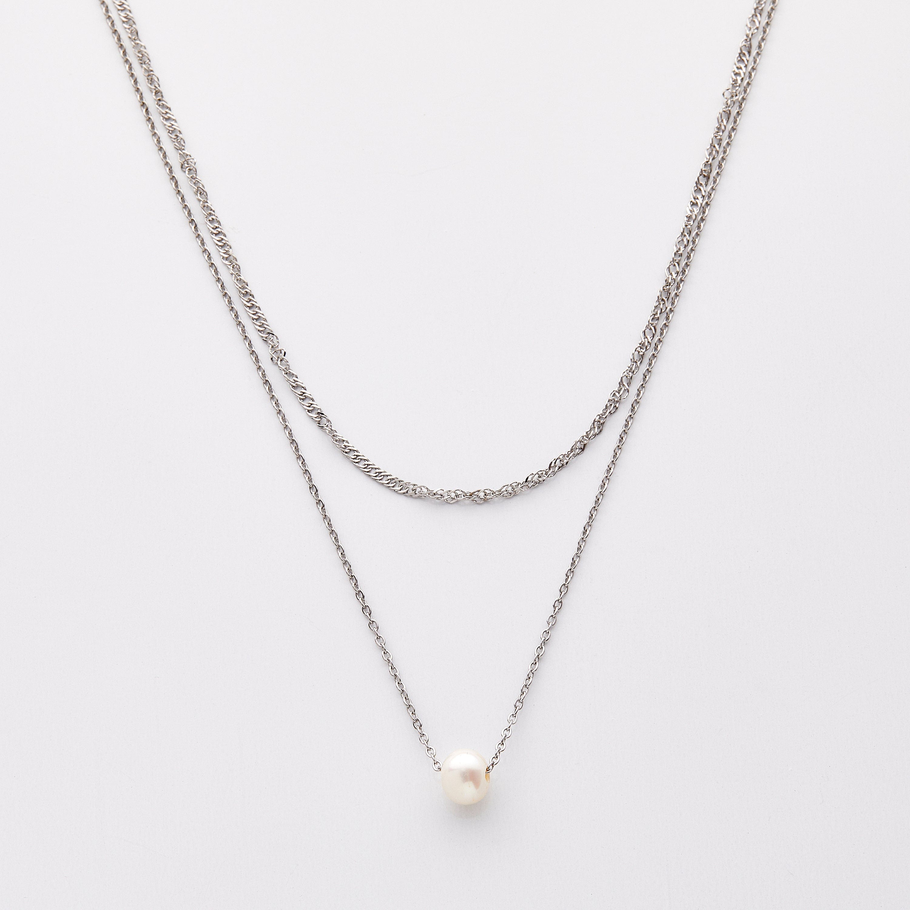 Elegant layered pearl necklace set displayed on a velvet background, showcasing the adjustable gold chain and freshwater pearl.