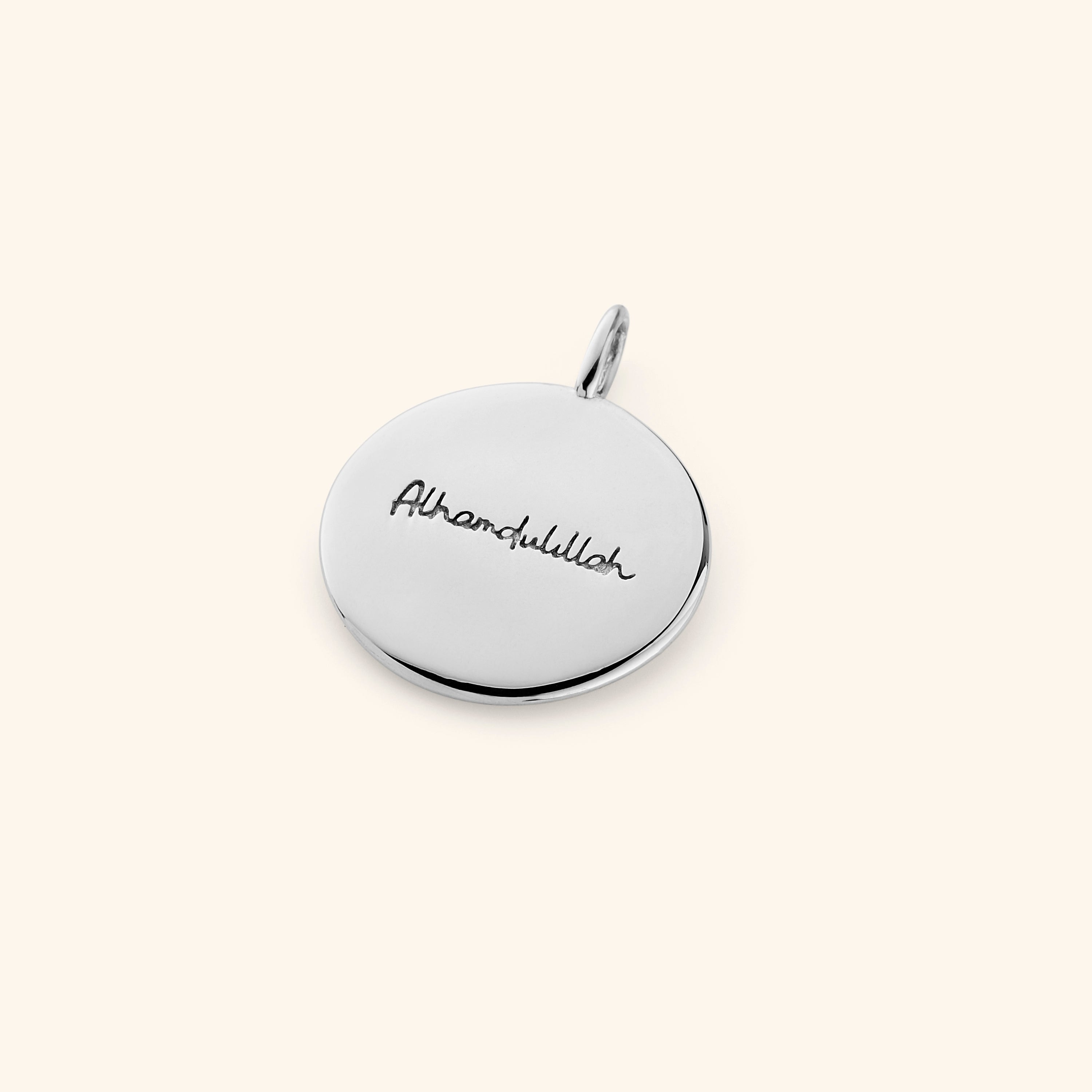 Close-up of the gold charm on a delicate chain, emphasizing its hypoallergenic properties.