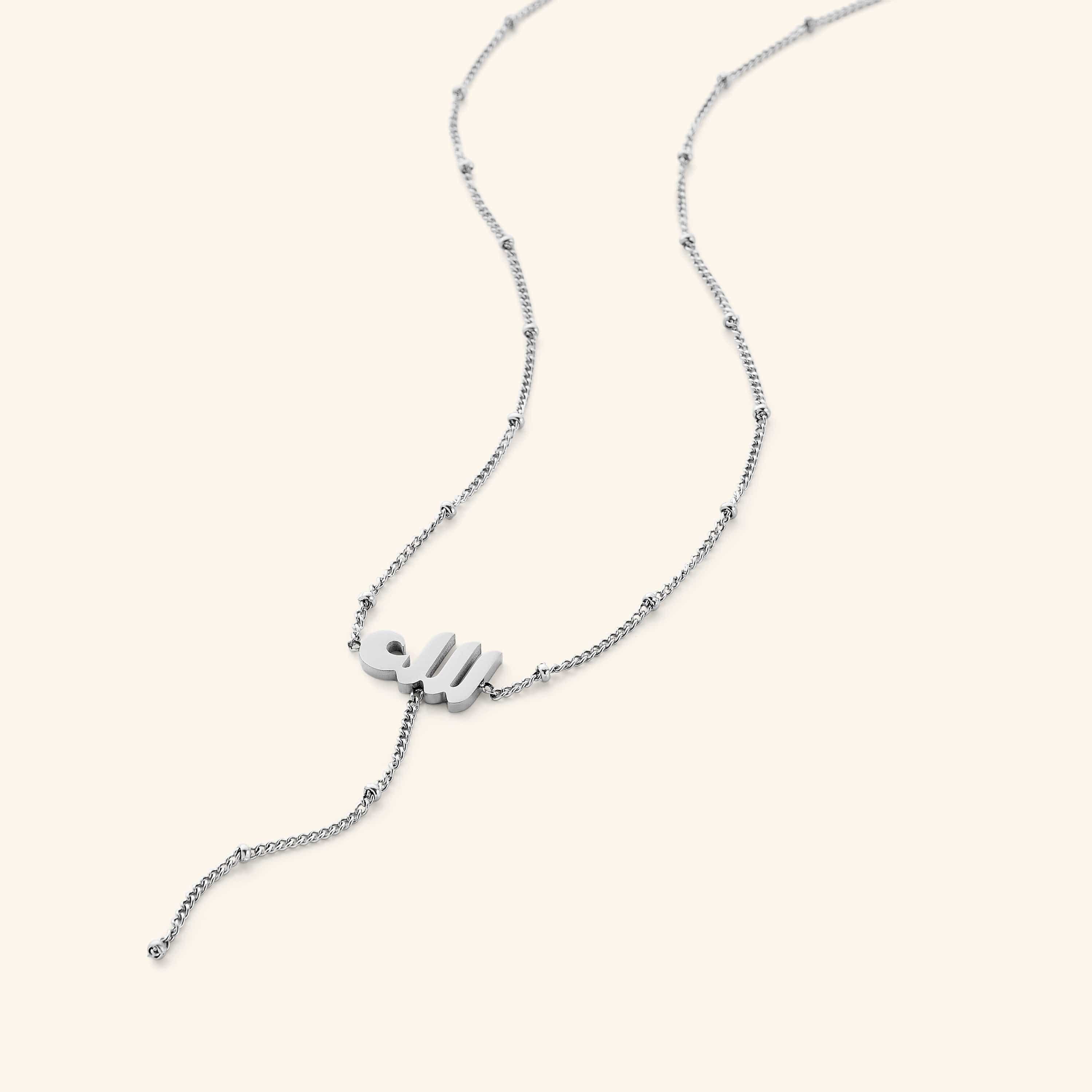 Model wearing the chic lariat necklace, emphasizing its elegant drop and overall style.