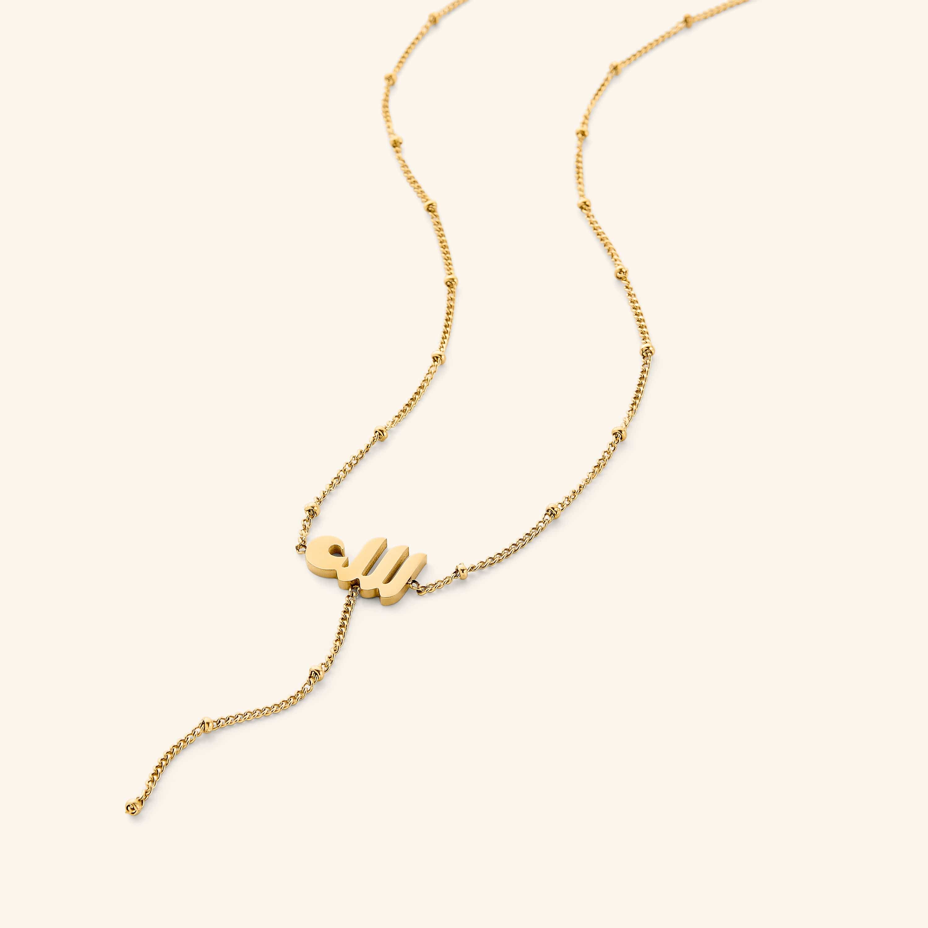 Chic Allah lariat necklace showcased against a soft velvet background.