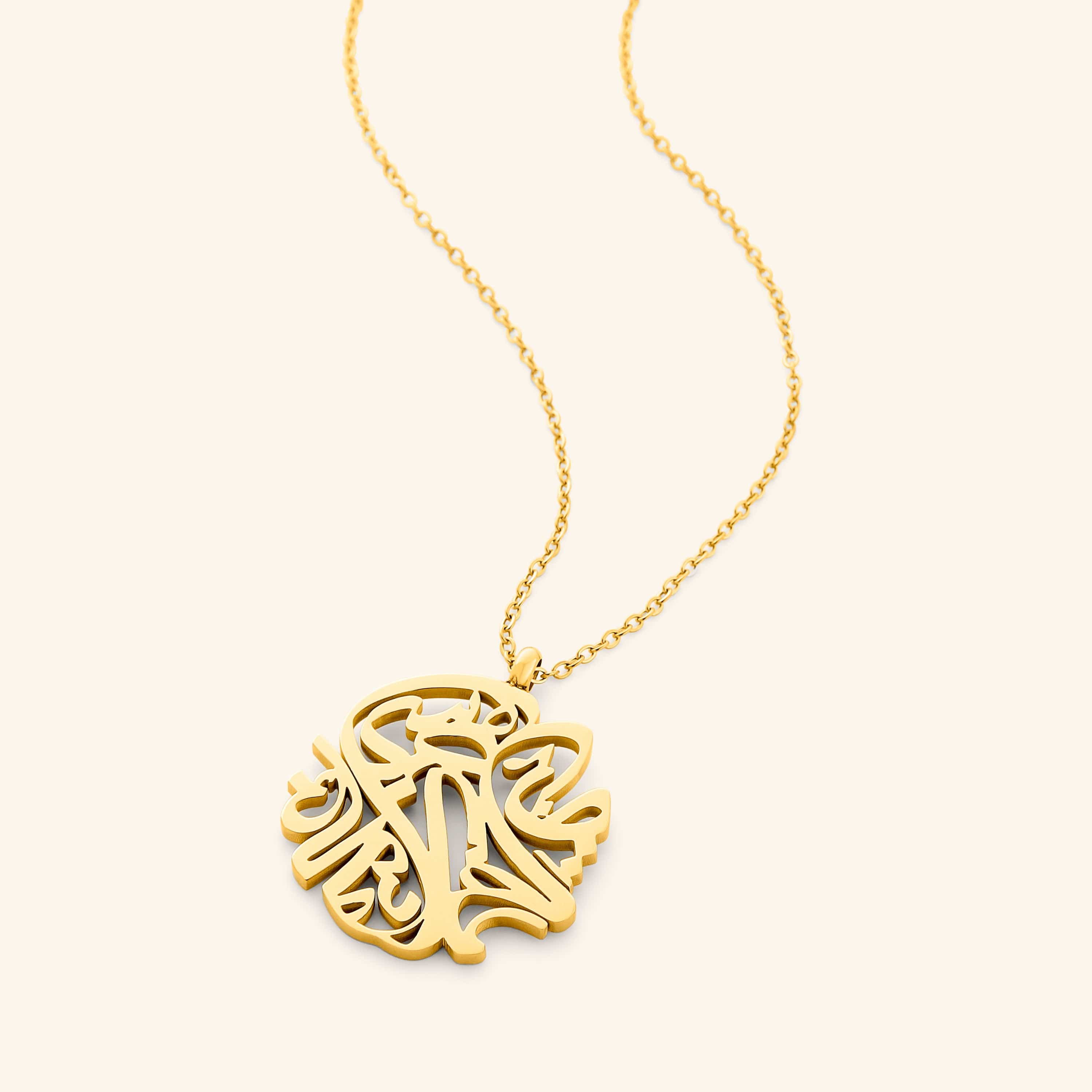 Elysian Relief Necklace displayed elegantly on a velvet pouch, showcasing its intricate Arabic calligraphy.