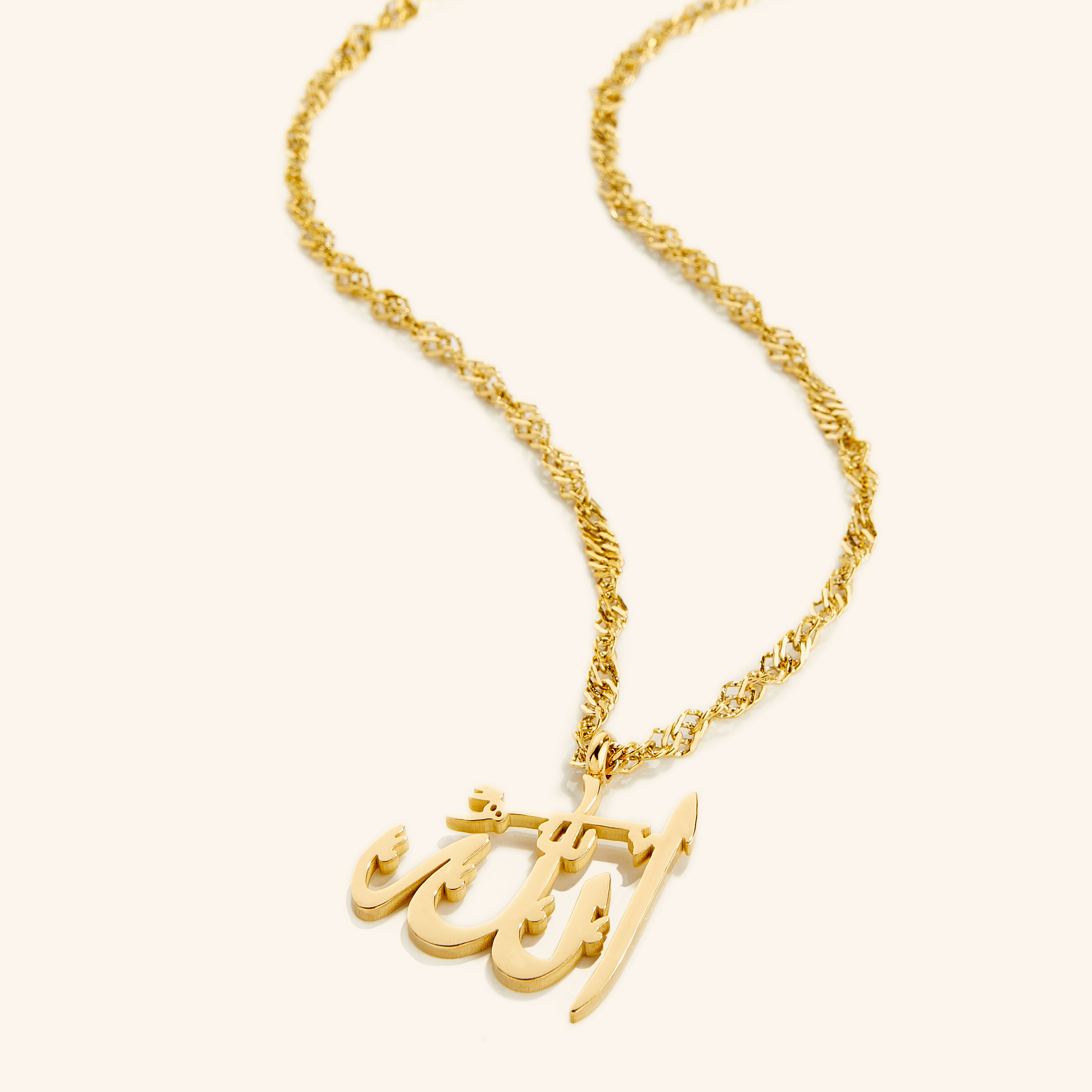Close-up view of the Allah pendant necklace showcasing its gold finish and intricate design.
