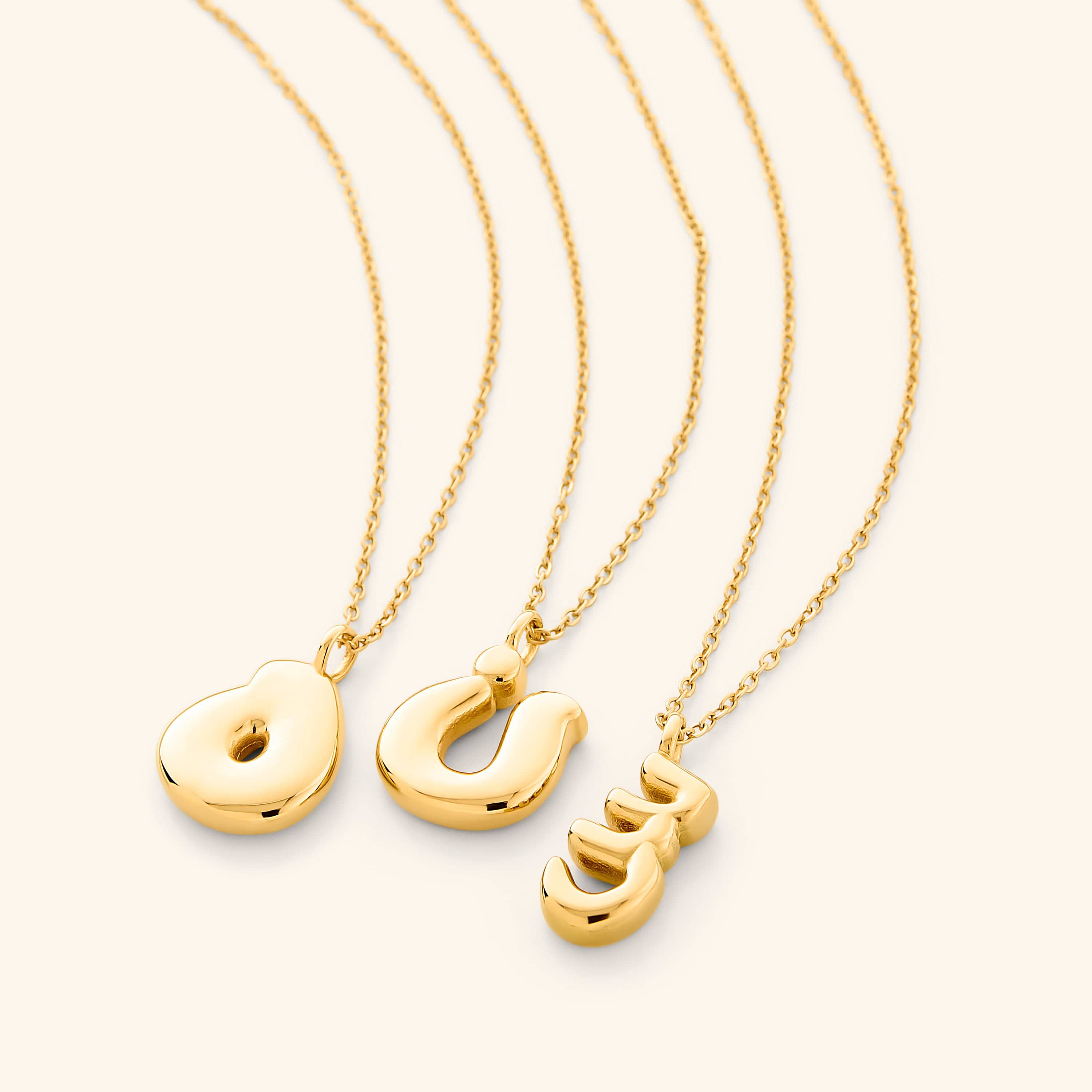 The Arabic bubble letter necklace displayed in a velvet pouch, ready for gift-giving.