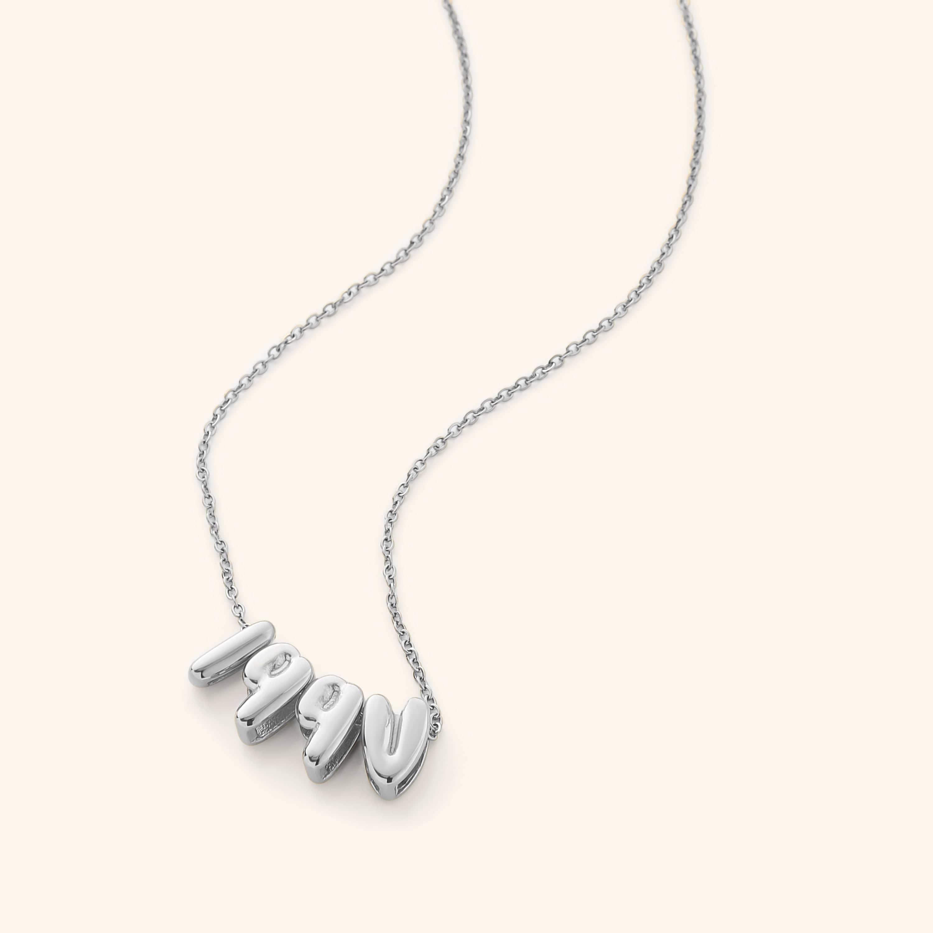 A woman wearing the Arabic birthyear necklace, emphasizing its stylish appeal and versatility.