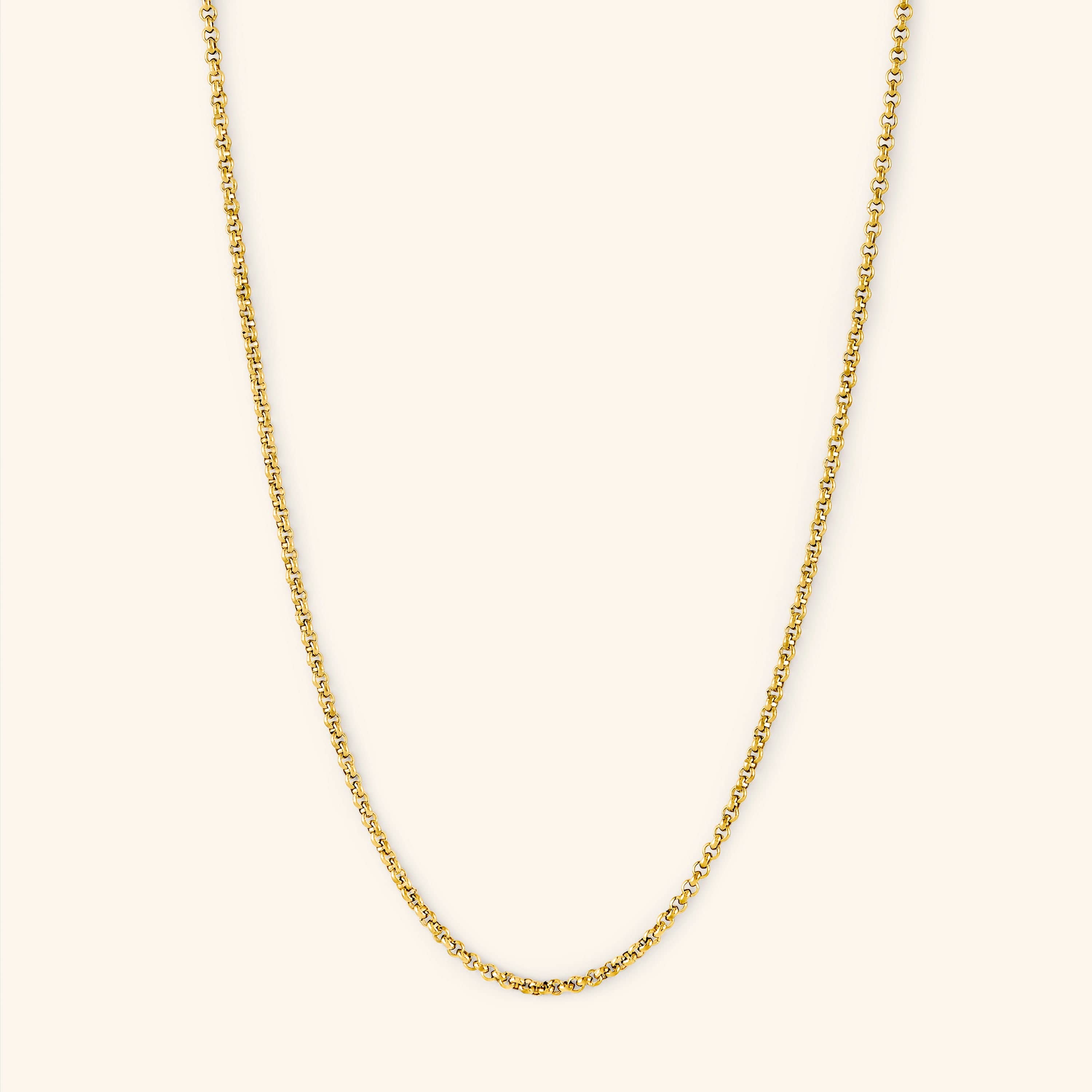 Close-up of the 18k gold box chain bracelet resting on a velvet pouch, showcasing minimalist design and hypoallergenic metal.