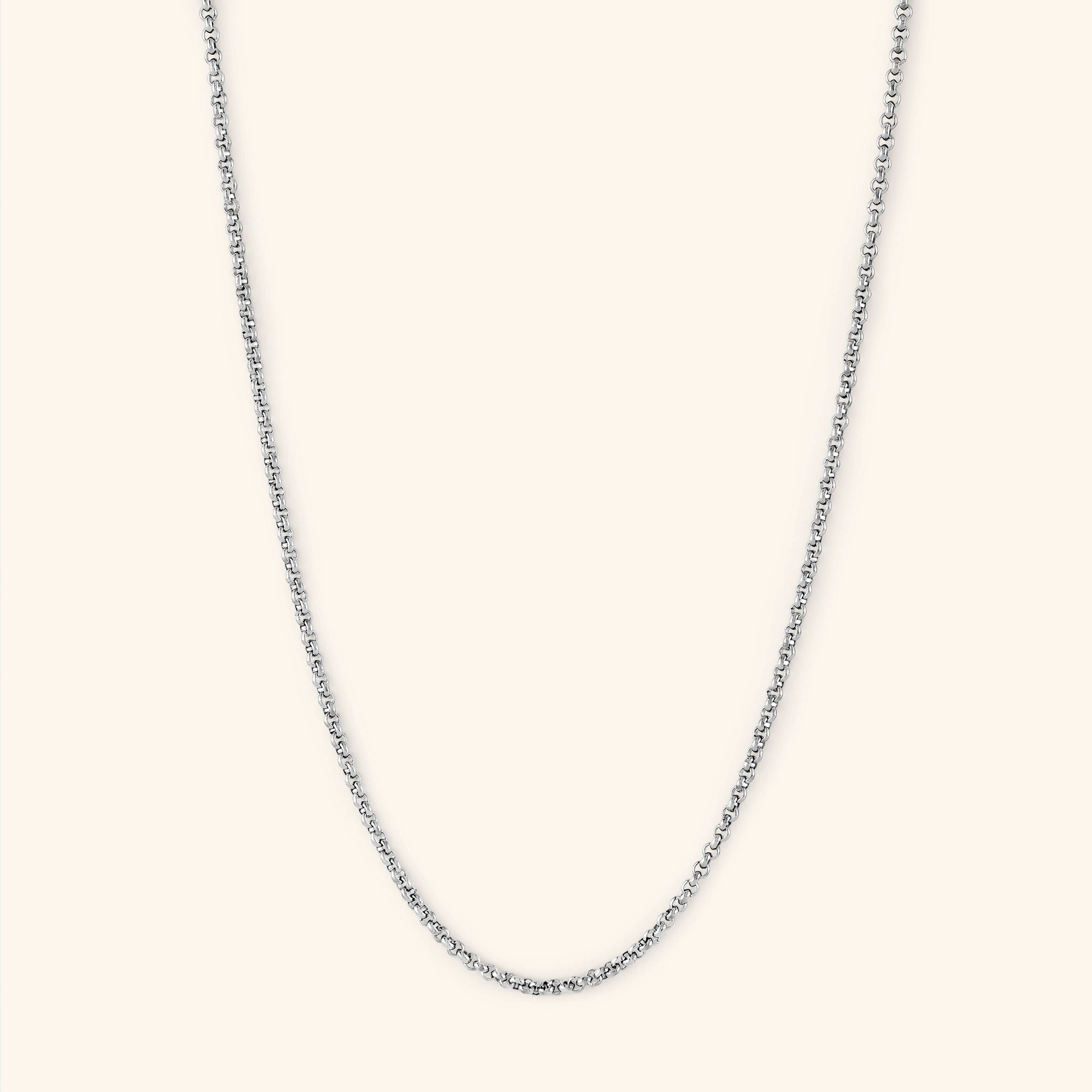 Flat lay of the Invisible Box Chain Bracelet with extension chain visible, highlighting adjustable length and gold shine.