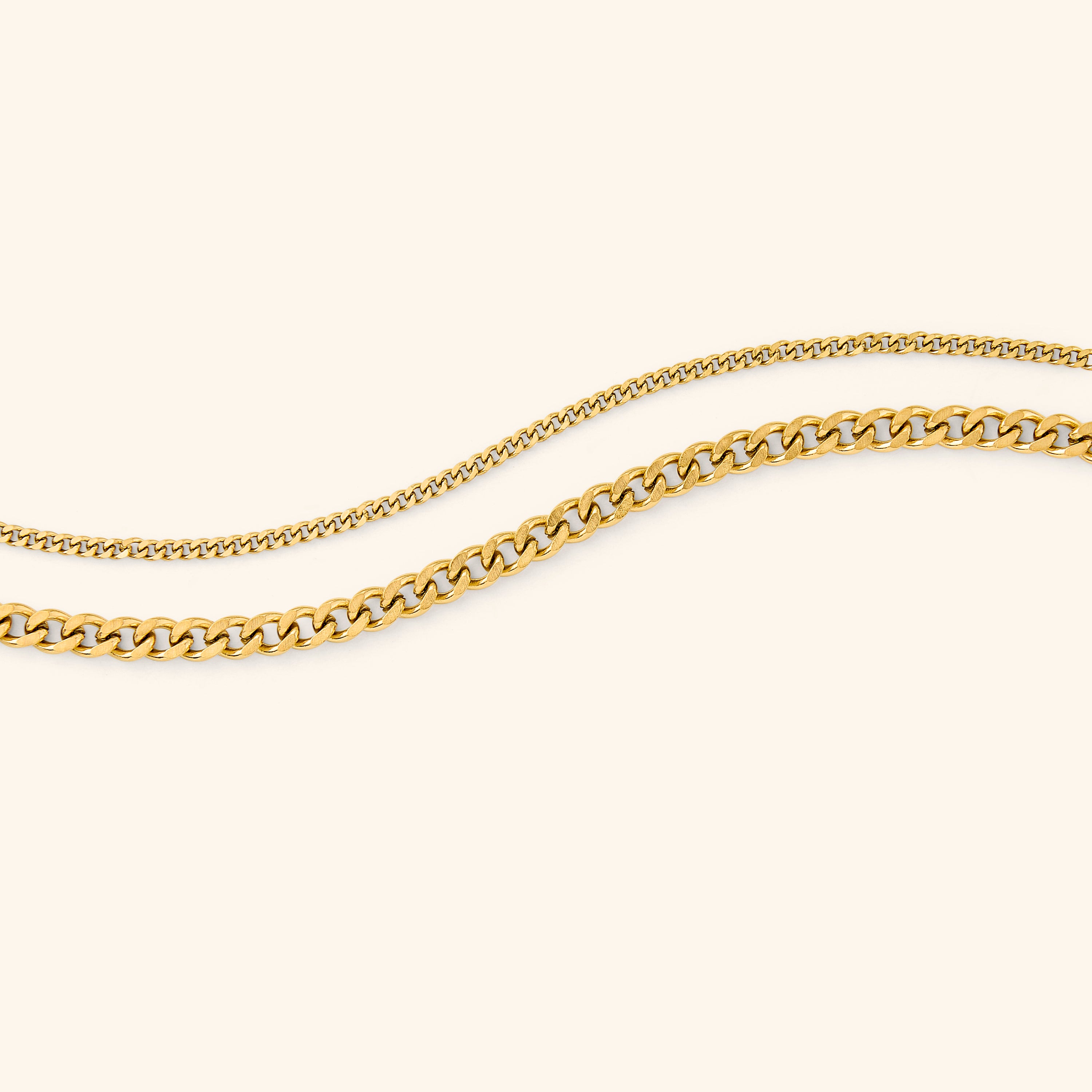 Close-up of the elegant gold curb chain bracelet showcasing its uniform link design.