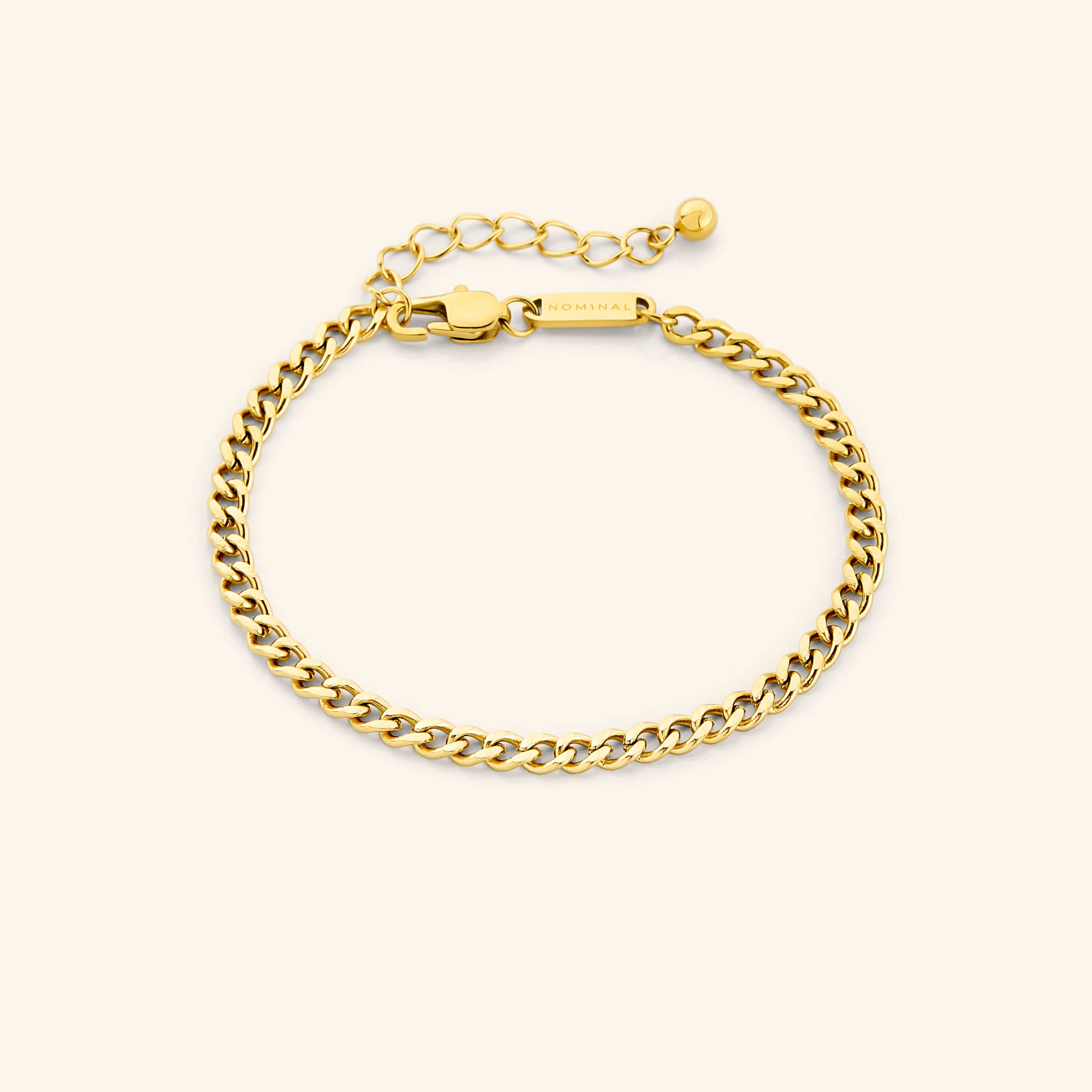 Close-up of the elegant gold curb chain bracelet showcasing its uniform link design.