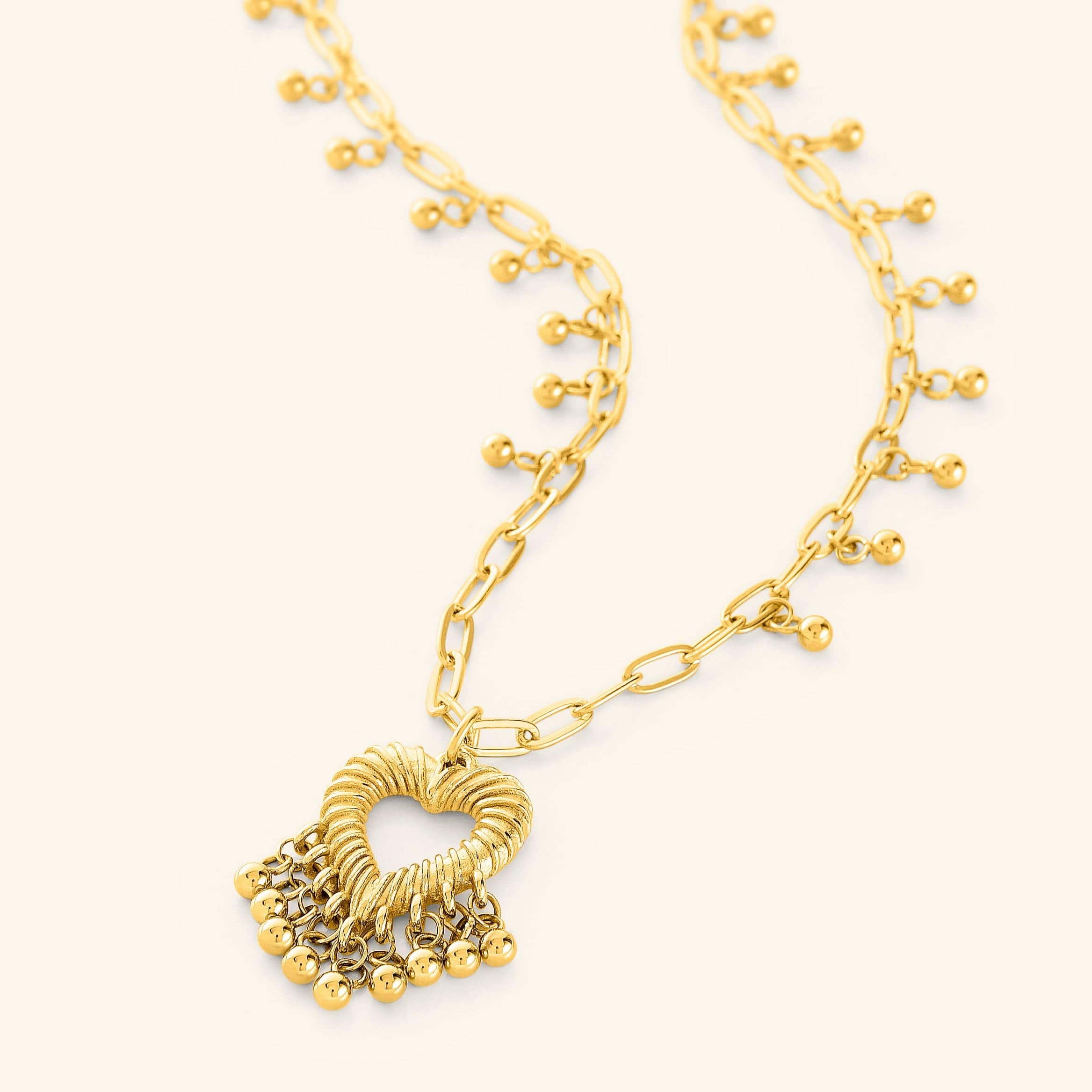 Close-up of the Ethereal Love Dangle Necklace highlighting the delicate gold orbs.