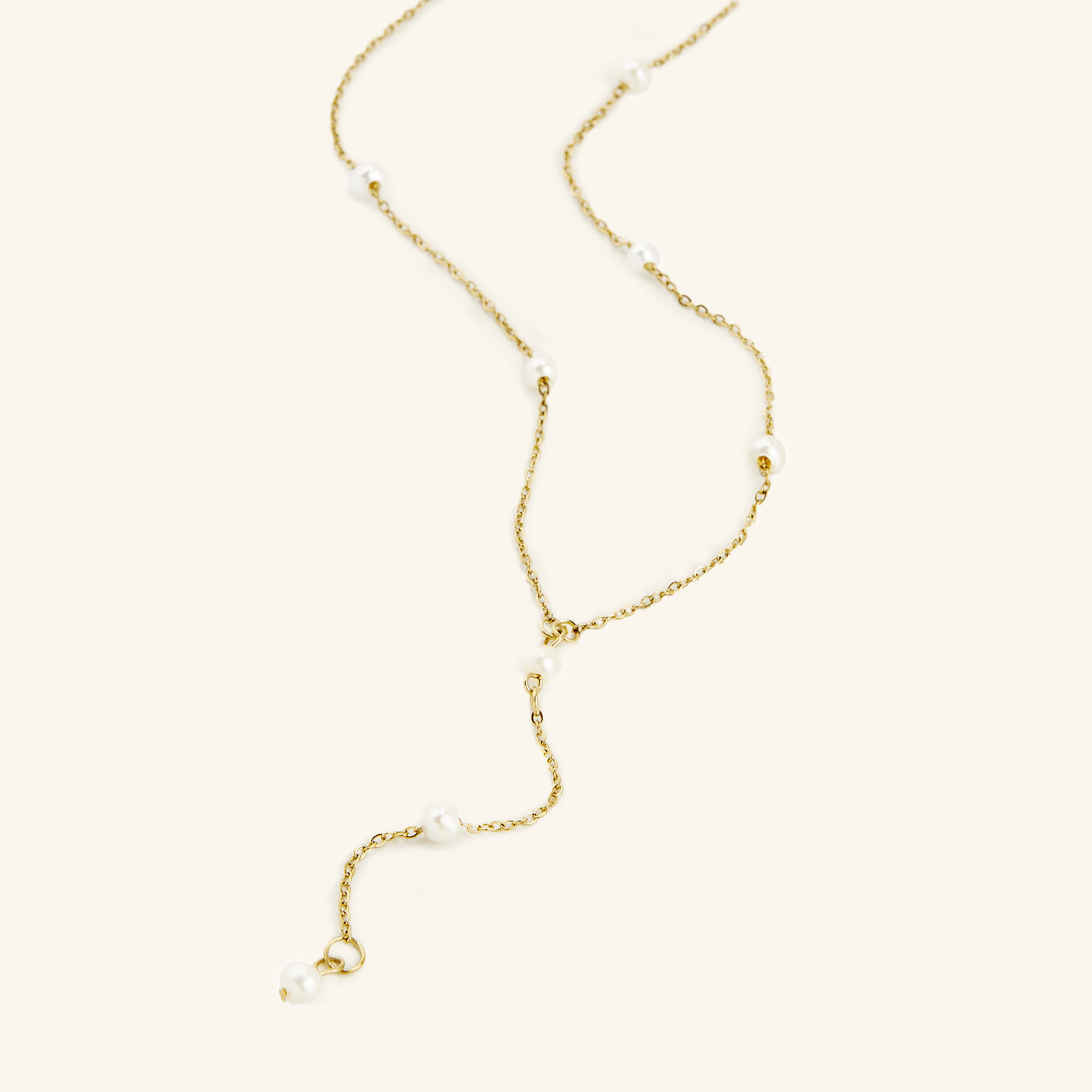 Close-up of pearl necklace highlighting 4mm freshwater pearls and lariat drop