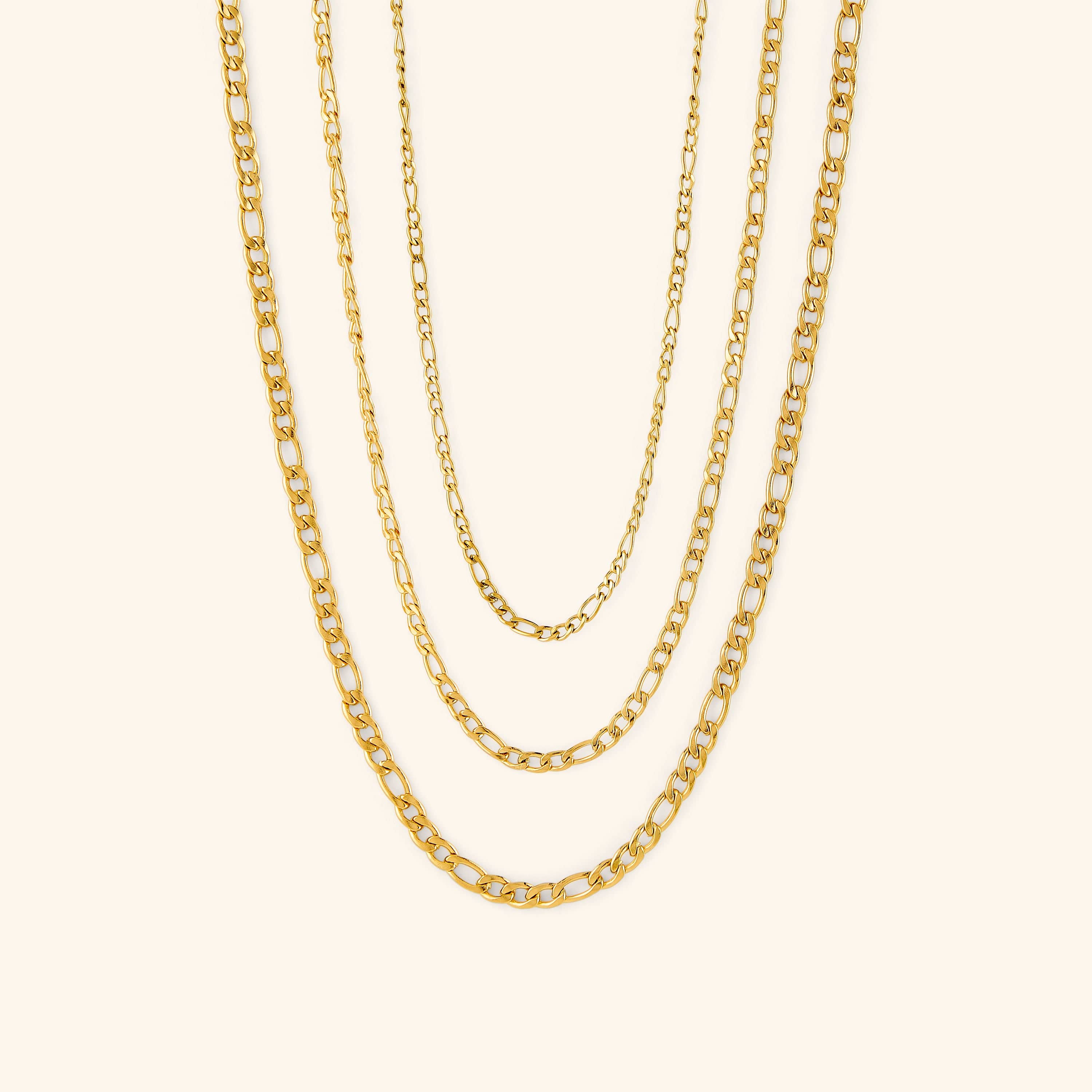 Elegant Figaro chain necklace displayed elegantly on a jewelry bust.