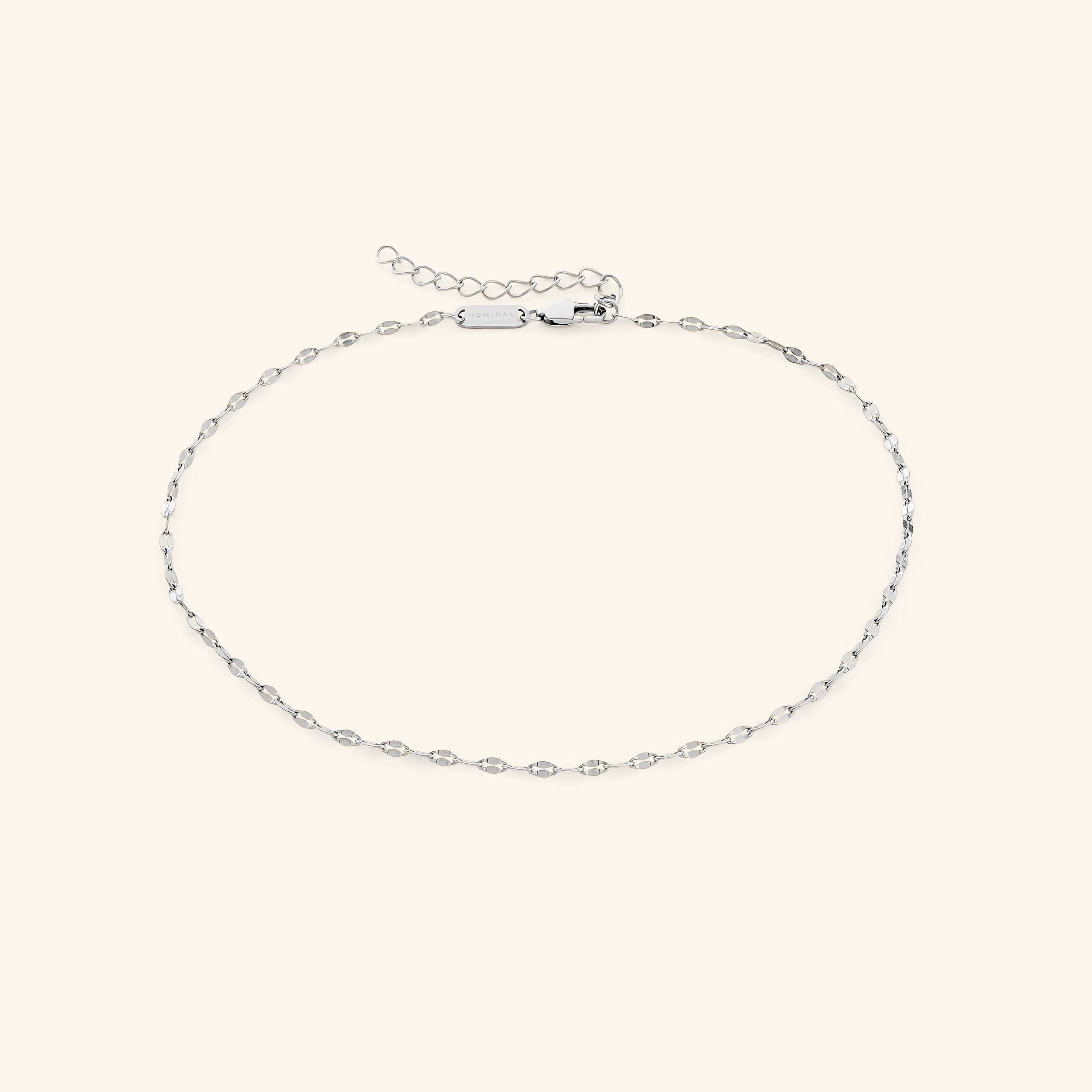 Model wearing the minimalist gold choker, highlighting its versatility with different outfits.