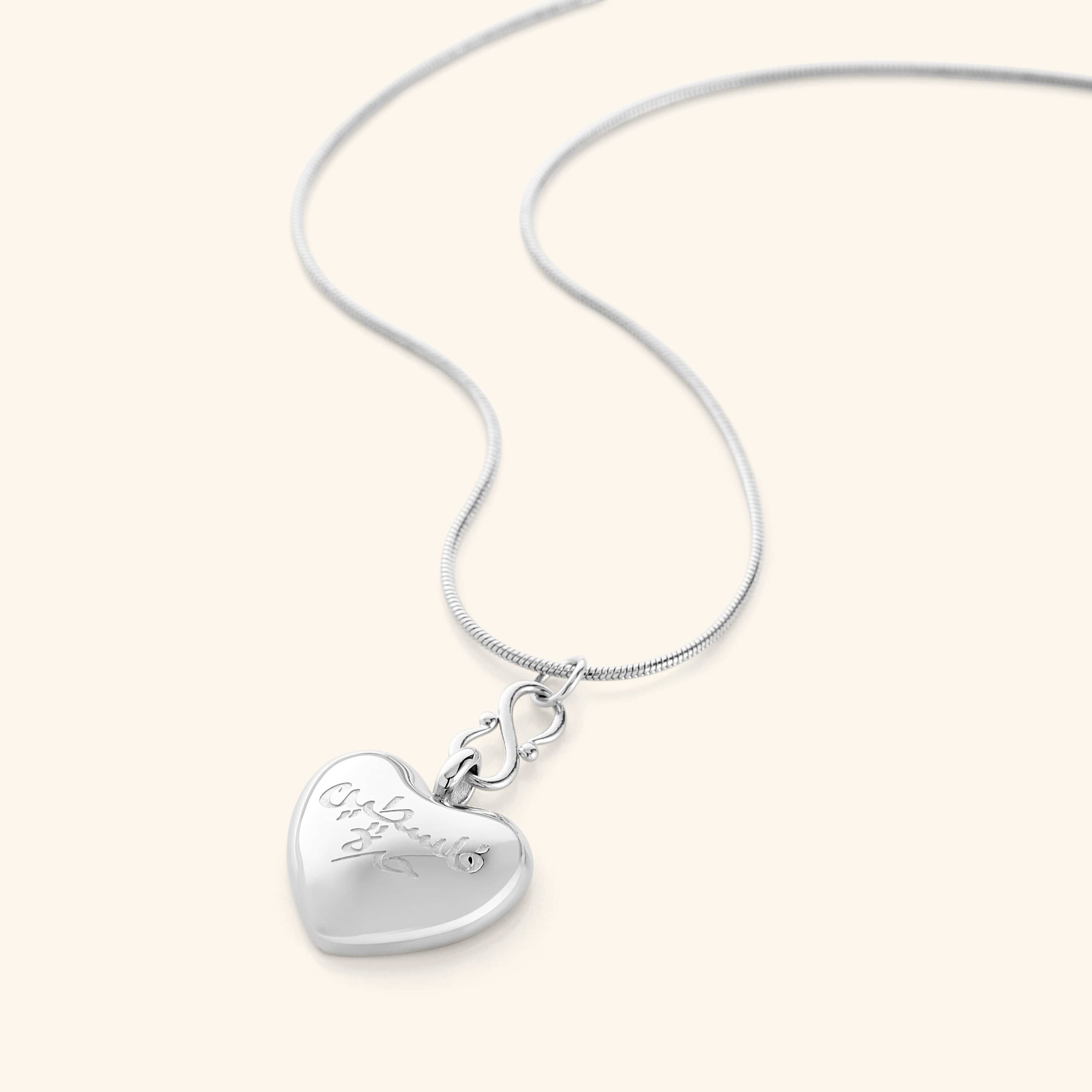 Model wearing the heart necklace, styled with casual attire for everyday use.