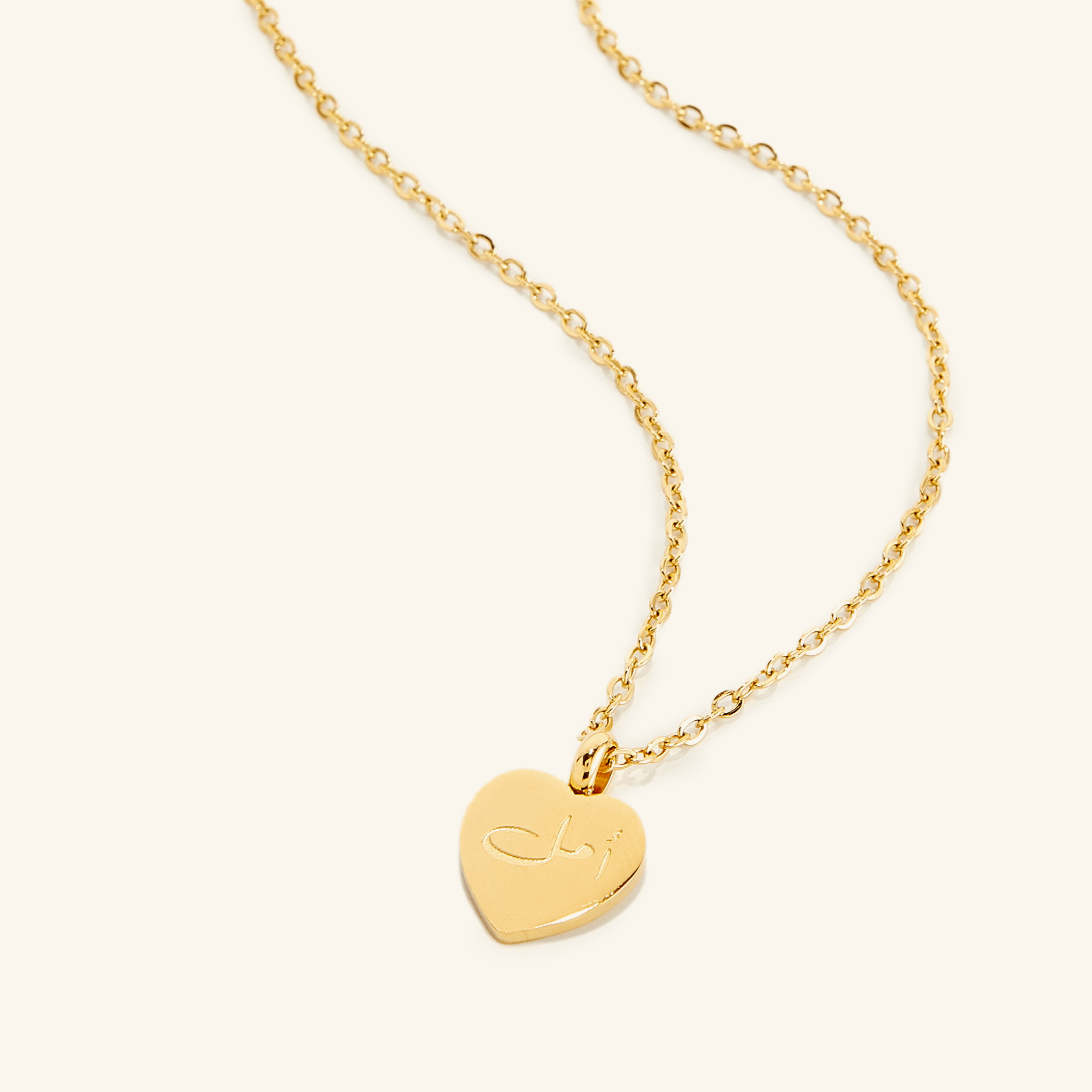 Close-up of the hope charm necklace, highlighting the 18K gold plating and hope pendant.