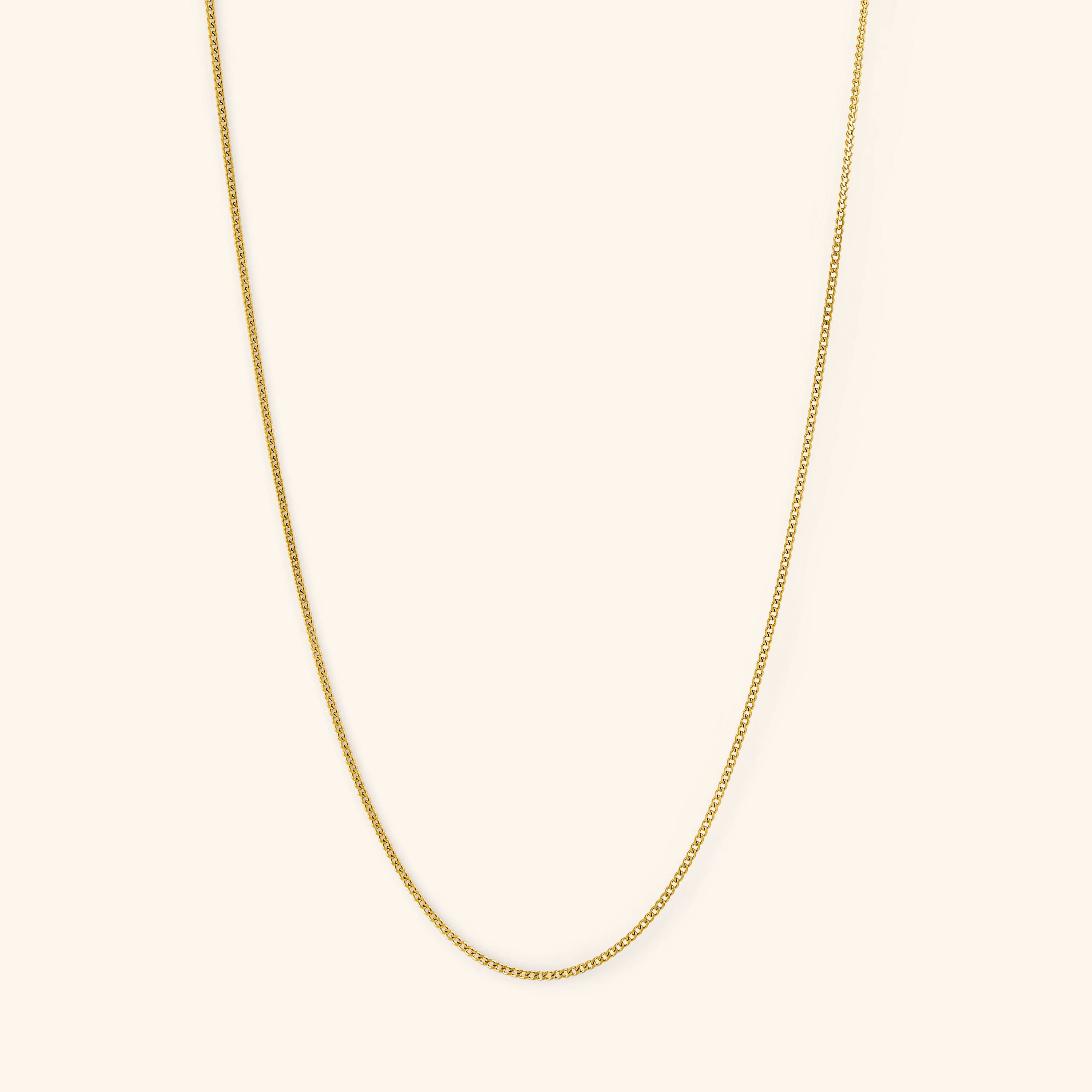Close-up of the Elegant Invisible Curb Chain Necklace showcasing its flat oval links and gold finish.