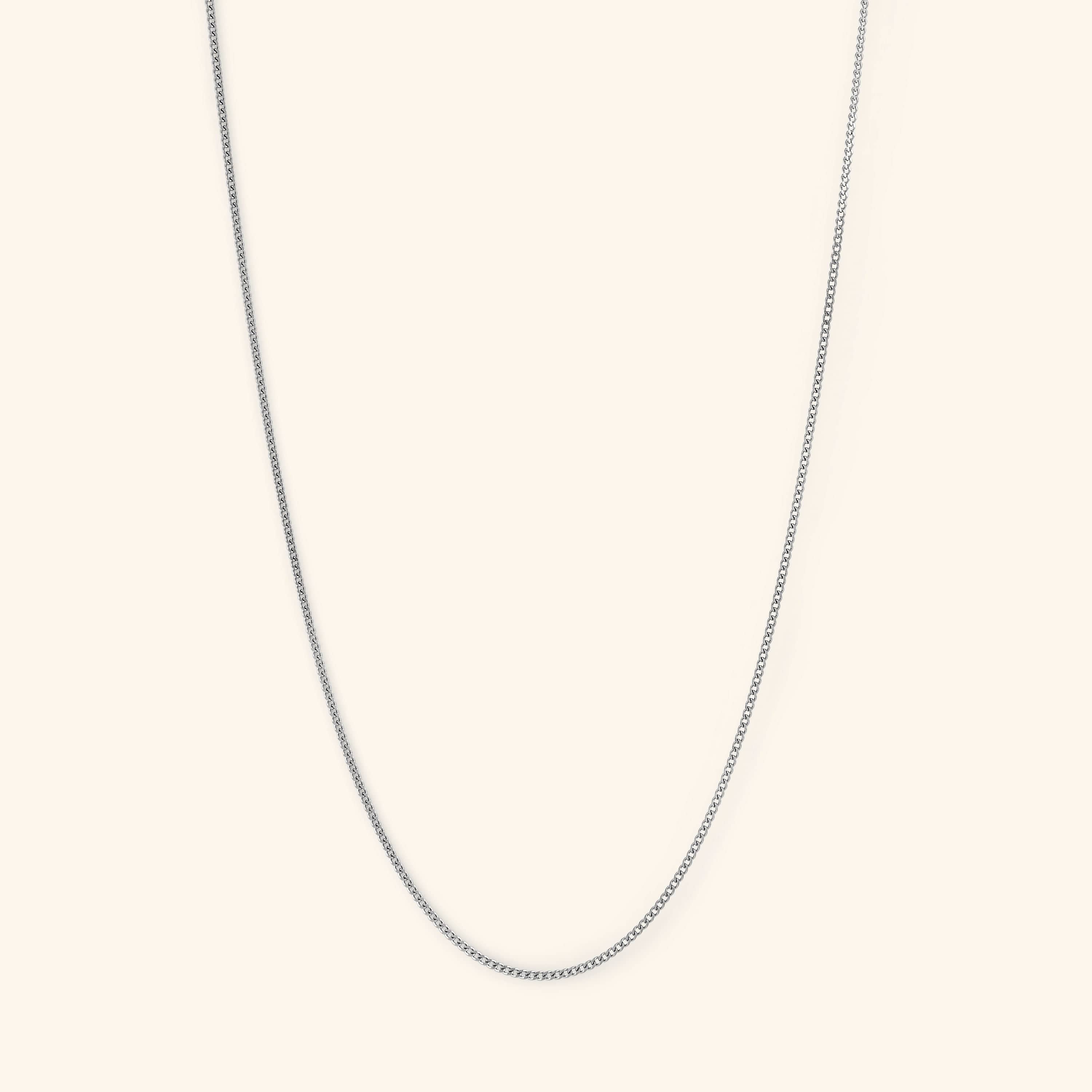 Model wearing the Elegant Invisible Curb Chain Necklace layered with other jewelry for a trendy look.
